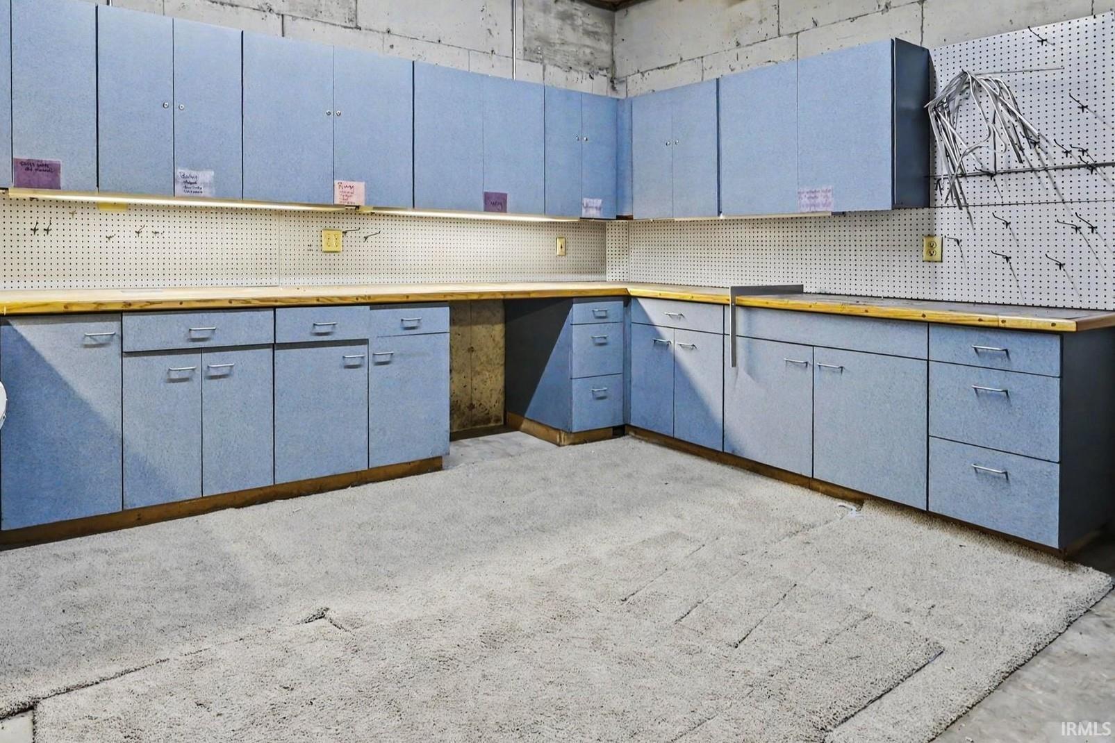 Extensive blue cabinetry with wood-finish countertops