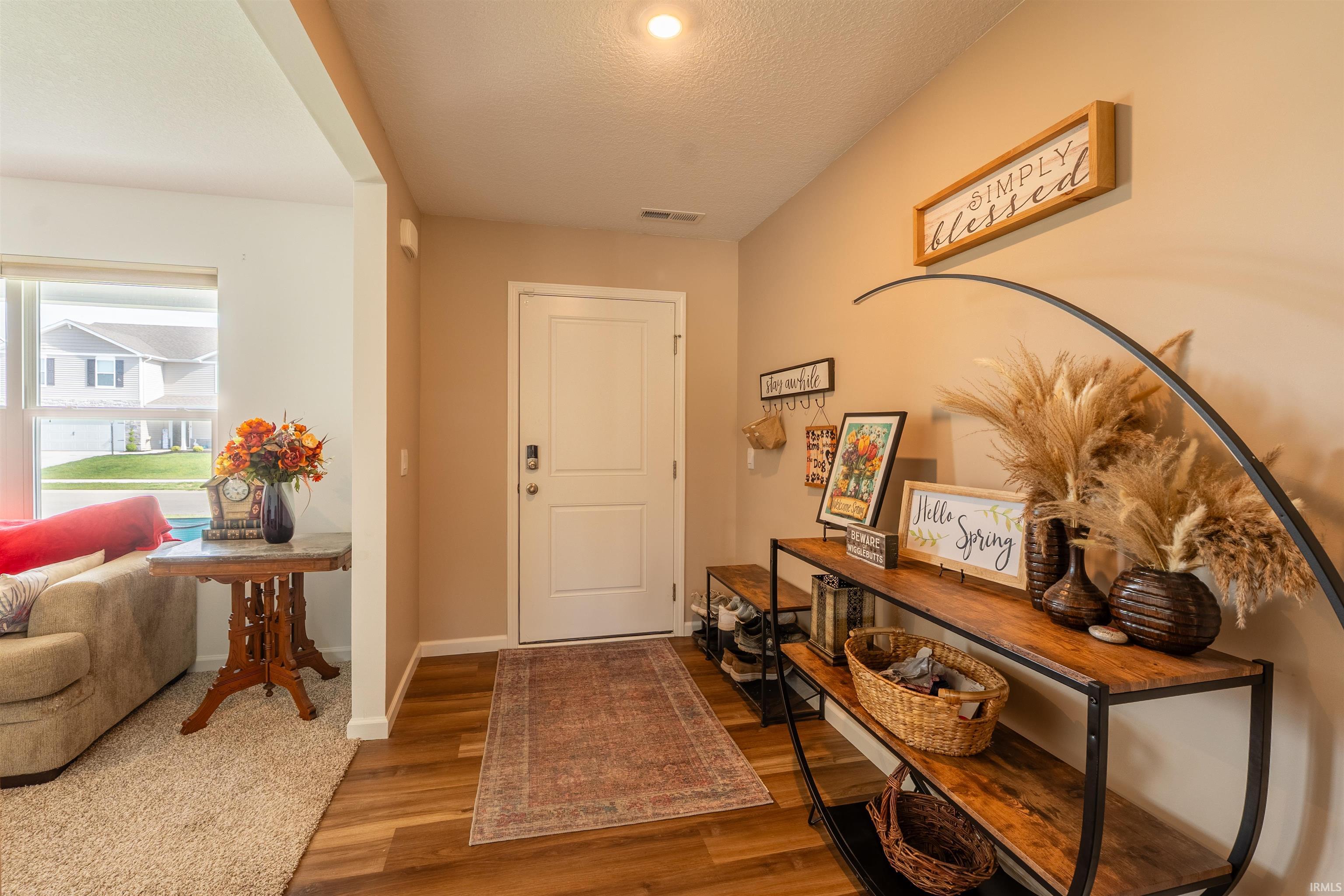 Entryway featuring wood-finish flooring and a white paneled door