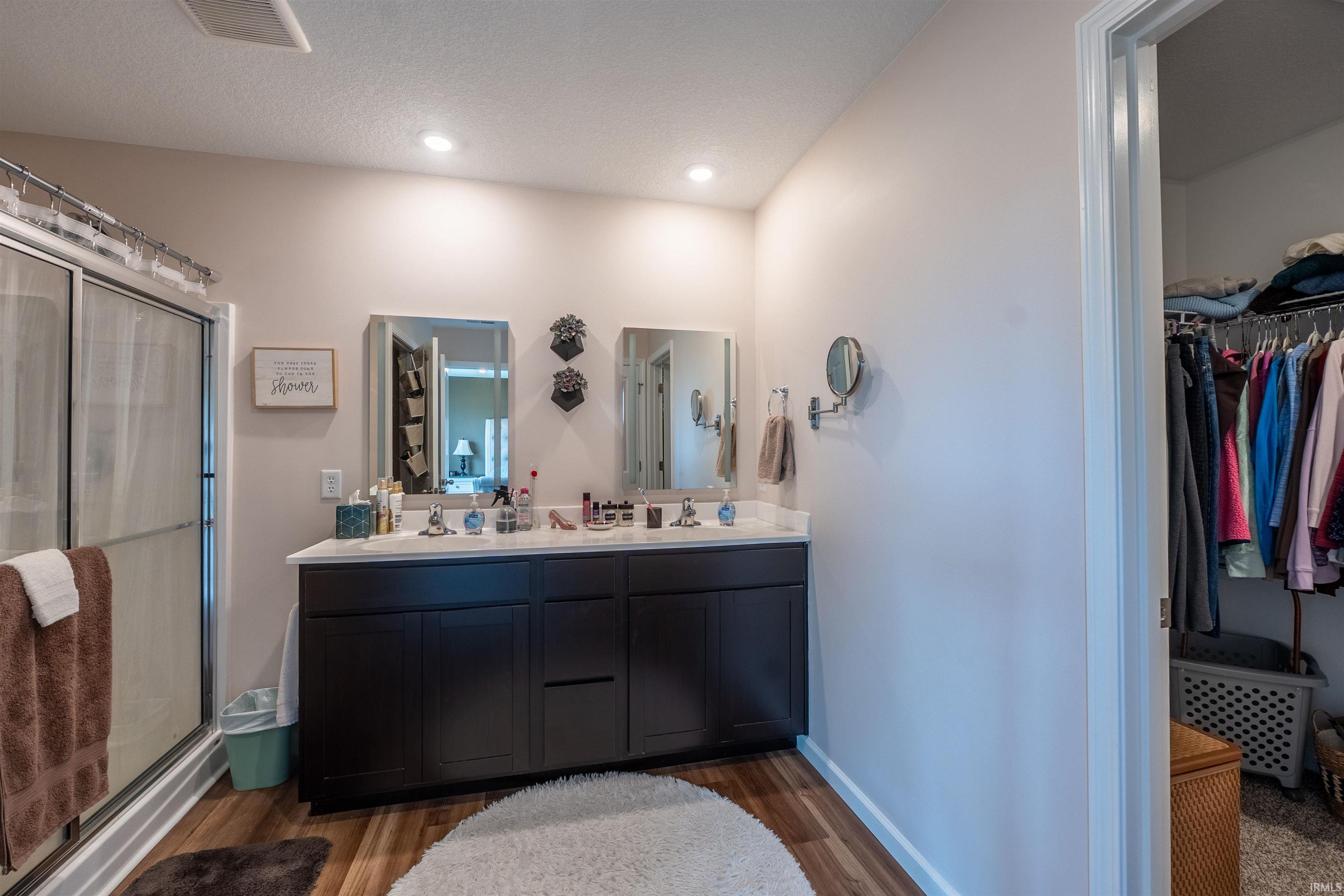 Double vanity featuring a light-colored countertop and dark wood-finish cabinetry
