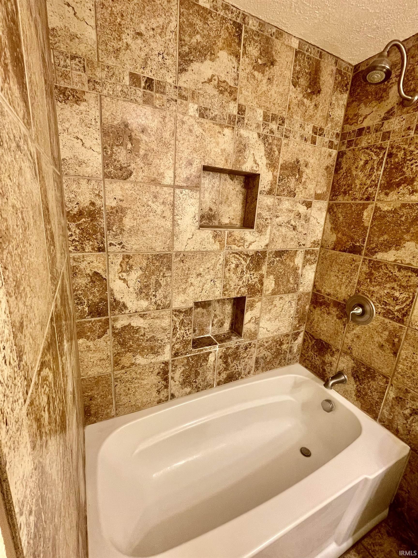 Bathtub with full-height patterned tile surround