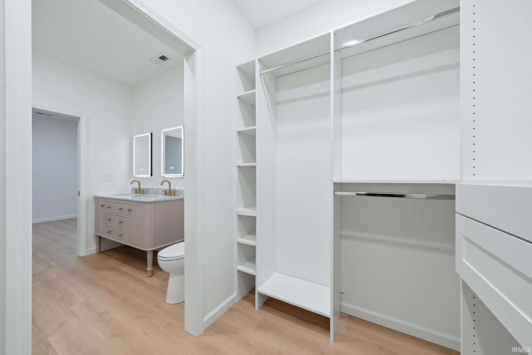 Custom closet system featuring shelving, hanging space, and drawers.