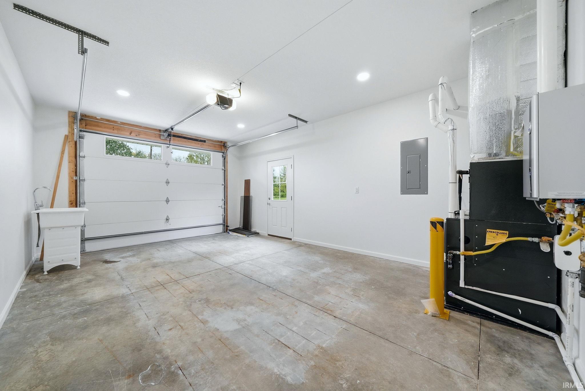 Attached garage with a roll-up door, integrated windows, and an automatic garage door opener