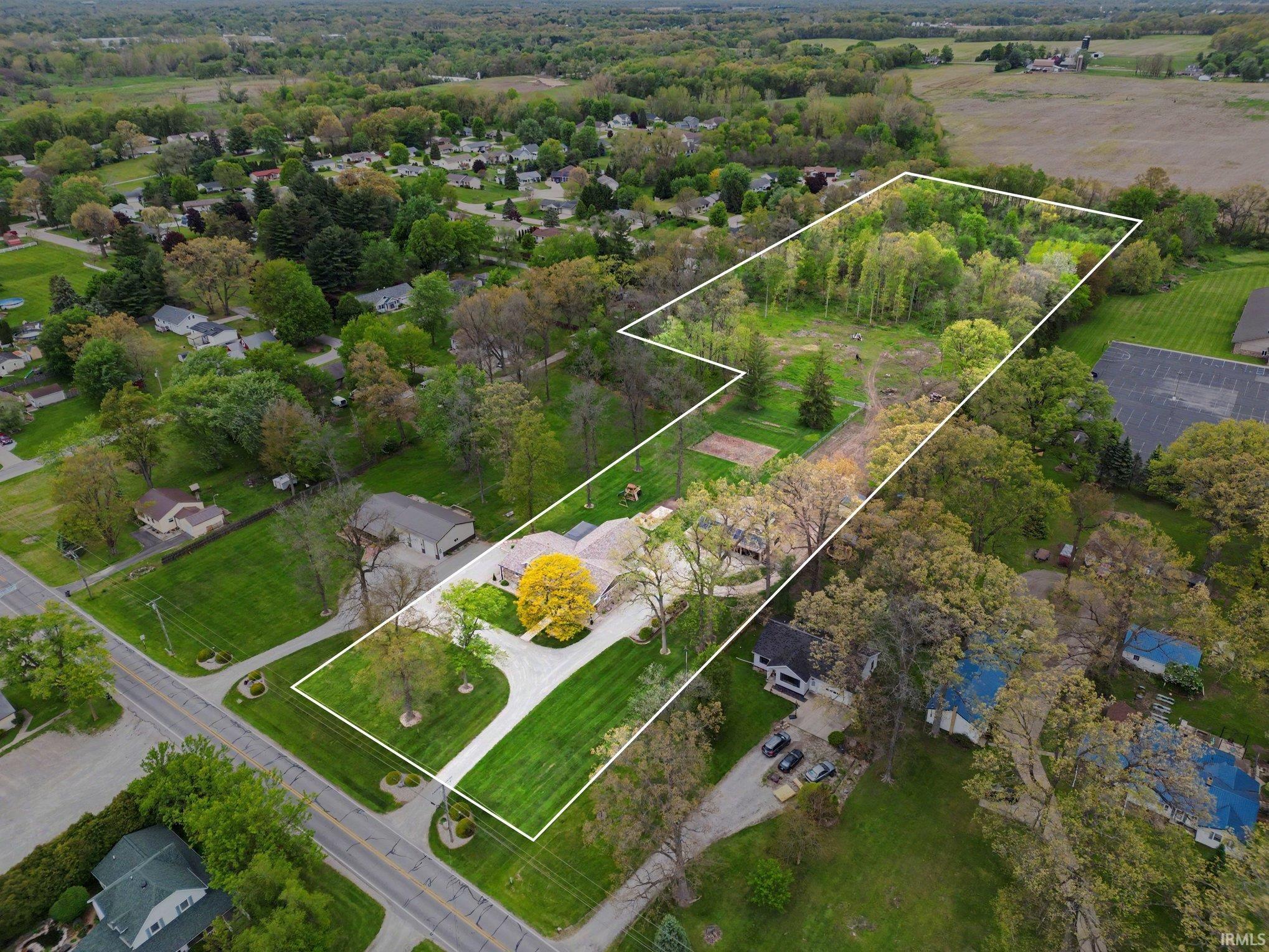 Expansive property with a long driveway and a large, manicured lawn