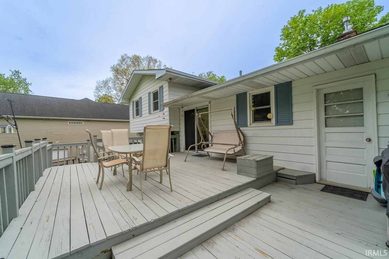 Expansive exterior deck featuring a railing system and steps
