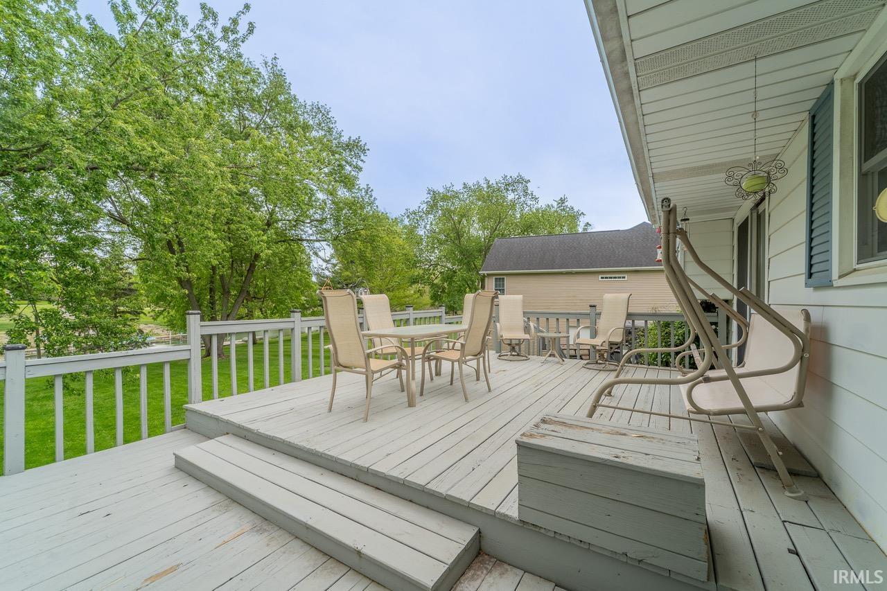 Spacious outdoor deck with painted wood flooring and white railing