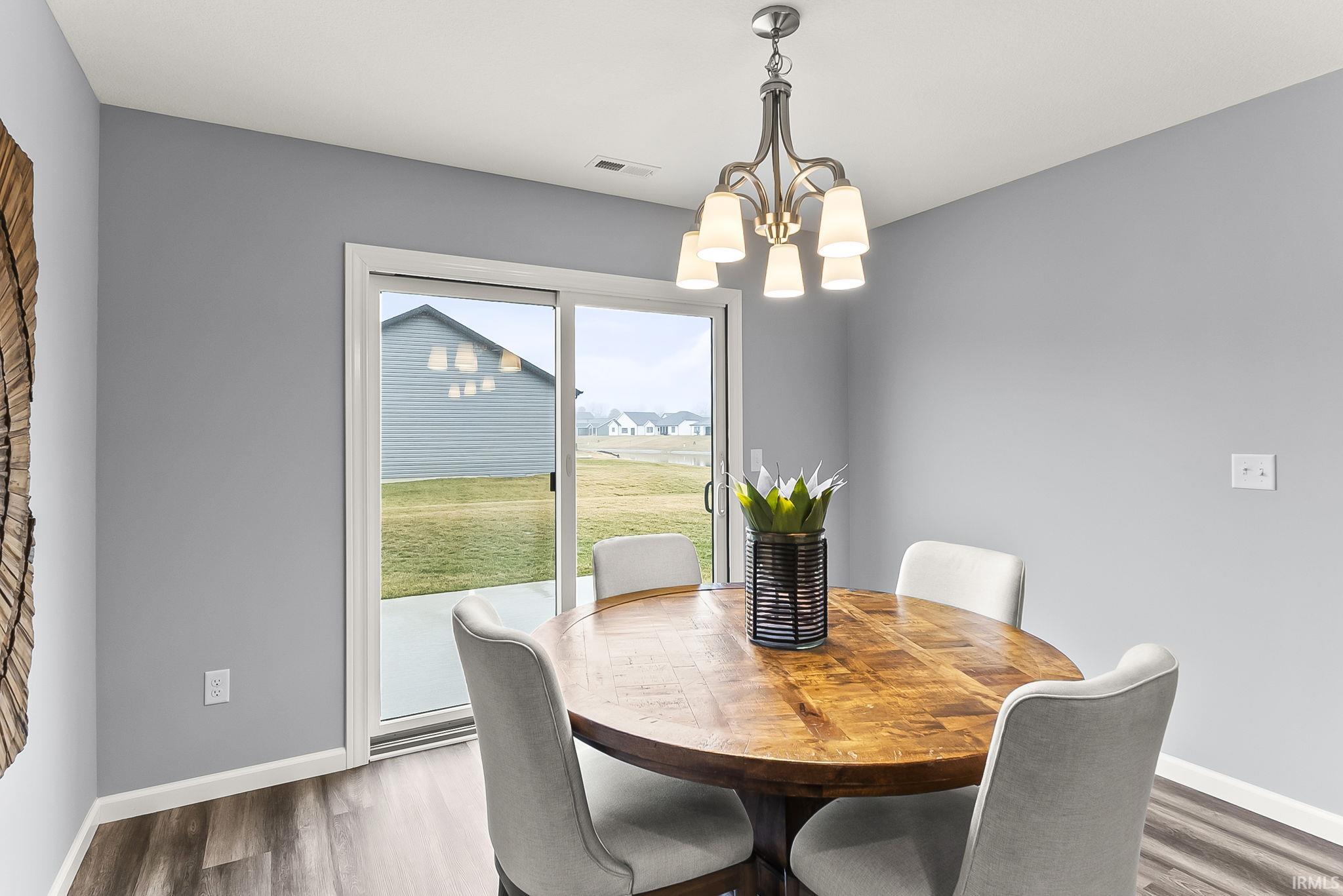 Dining space with a sliding glass door providing access to the concrete patio