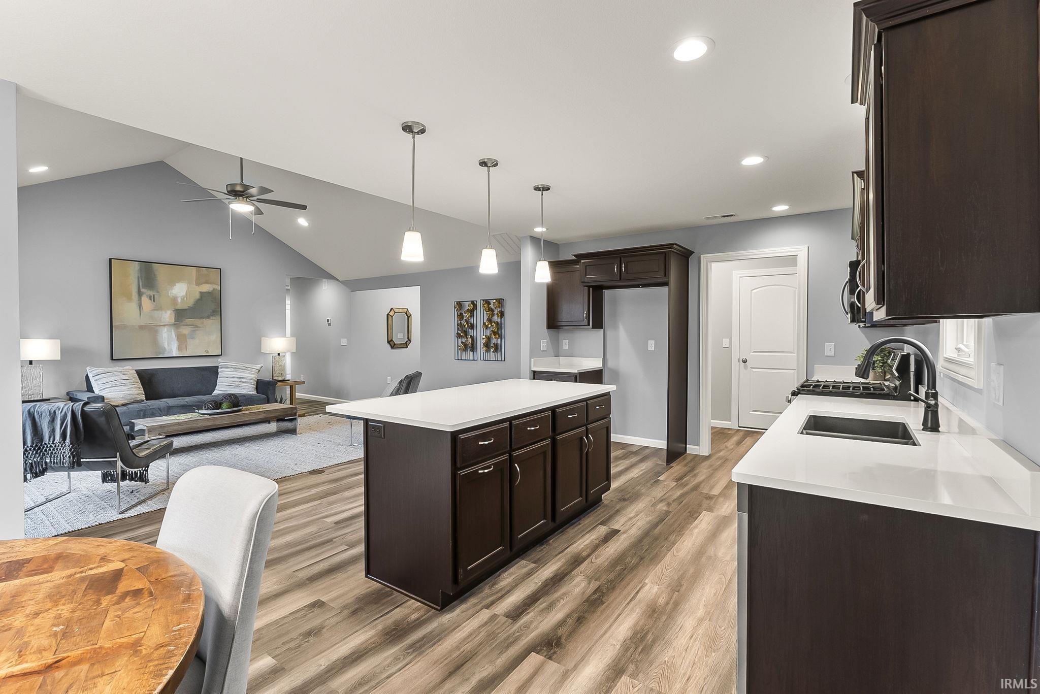 Open concept living area featuring wood-finish flooring