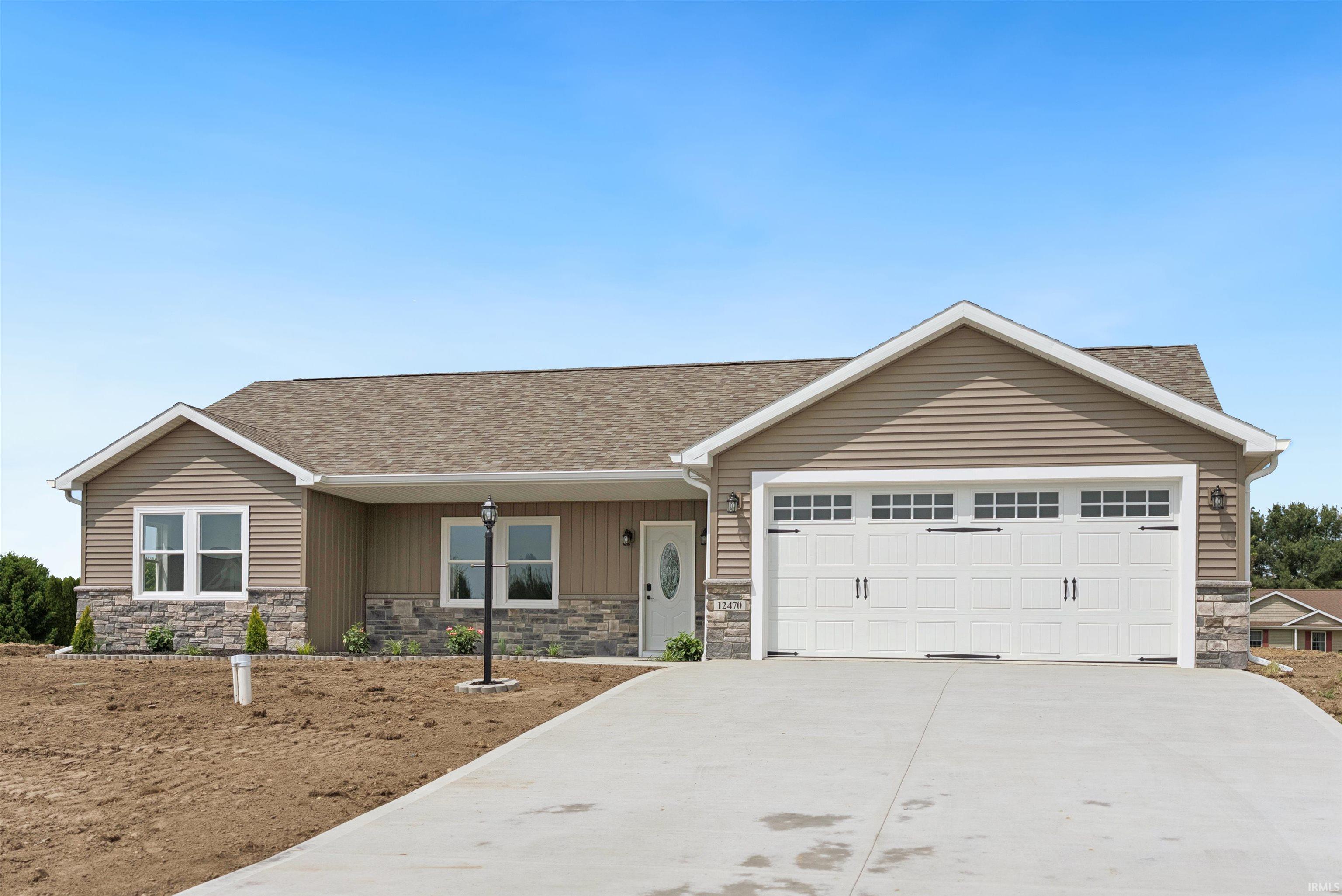 Ranch-style residence featuring a stone veneer facade, horizontal siding, and a gabled roofline