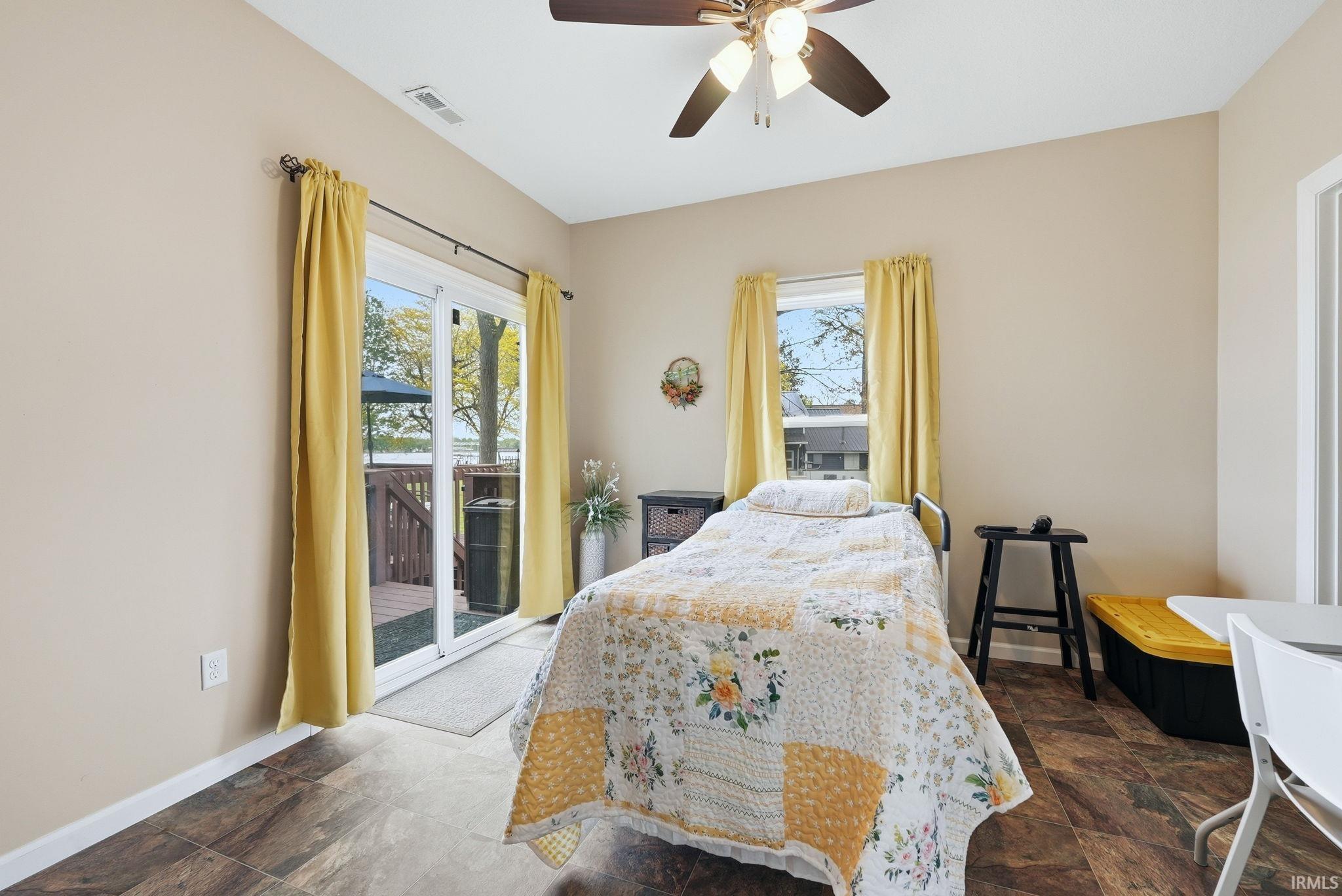 Spacious room featuring wood-finish flooring and neutral wall tones