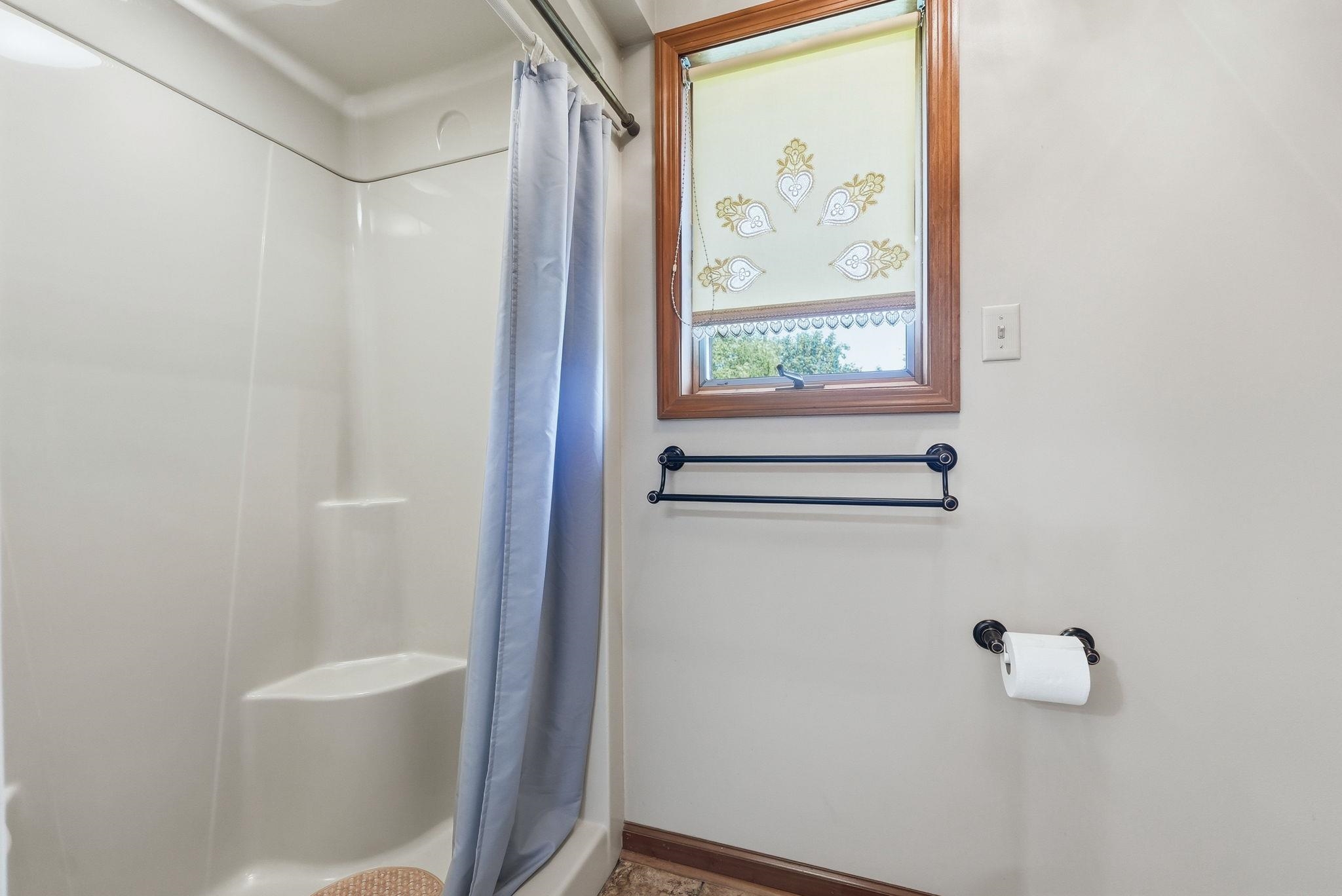 White shower enclosure with integrated seating