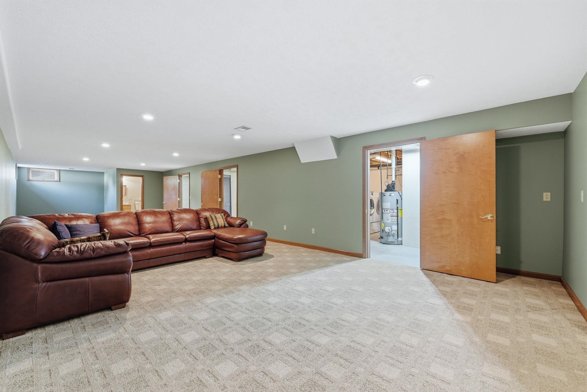 Spacious room featuring patterned carpet flooring, recessed ceiling lighting, and a neutral wall color