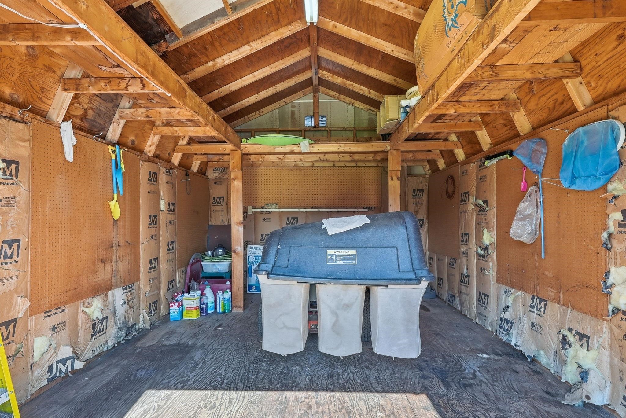 Utility shed interior featuring sound system, 220 electricity, and new extra solar cover for pool. New filter for pool if you ever need one.                                       MOWER IS NOT INCLUDED WITH PROPERTY