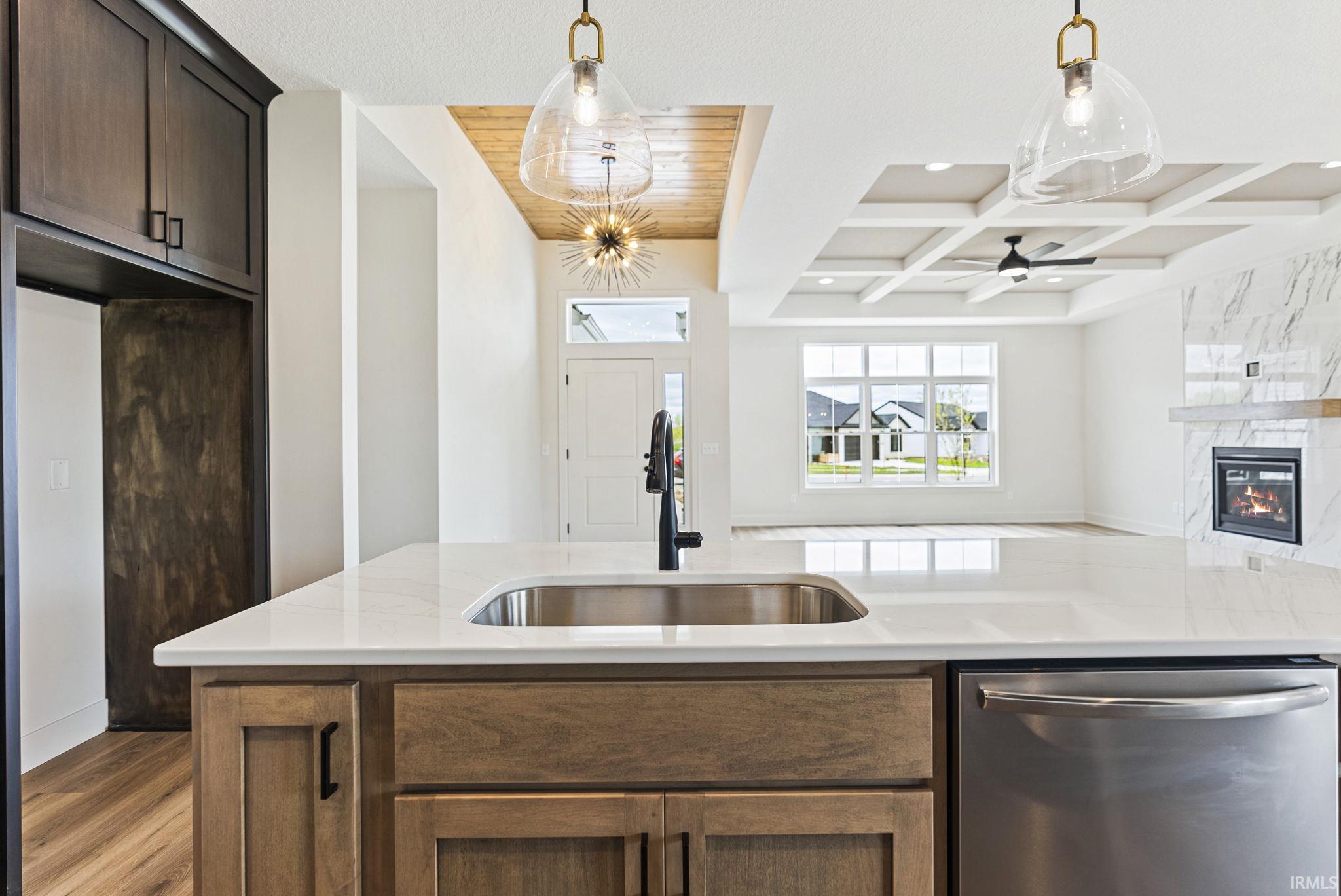 Kitchen island with an undermount sink, a gooseneck faucet, and a stainless steel dishwasher