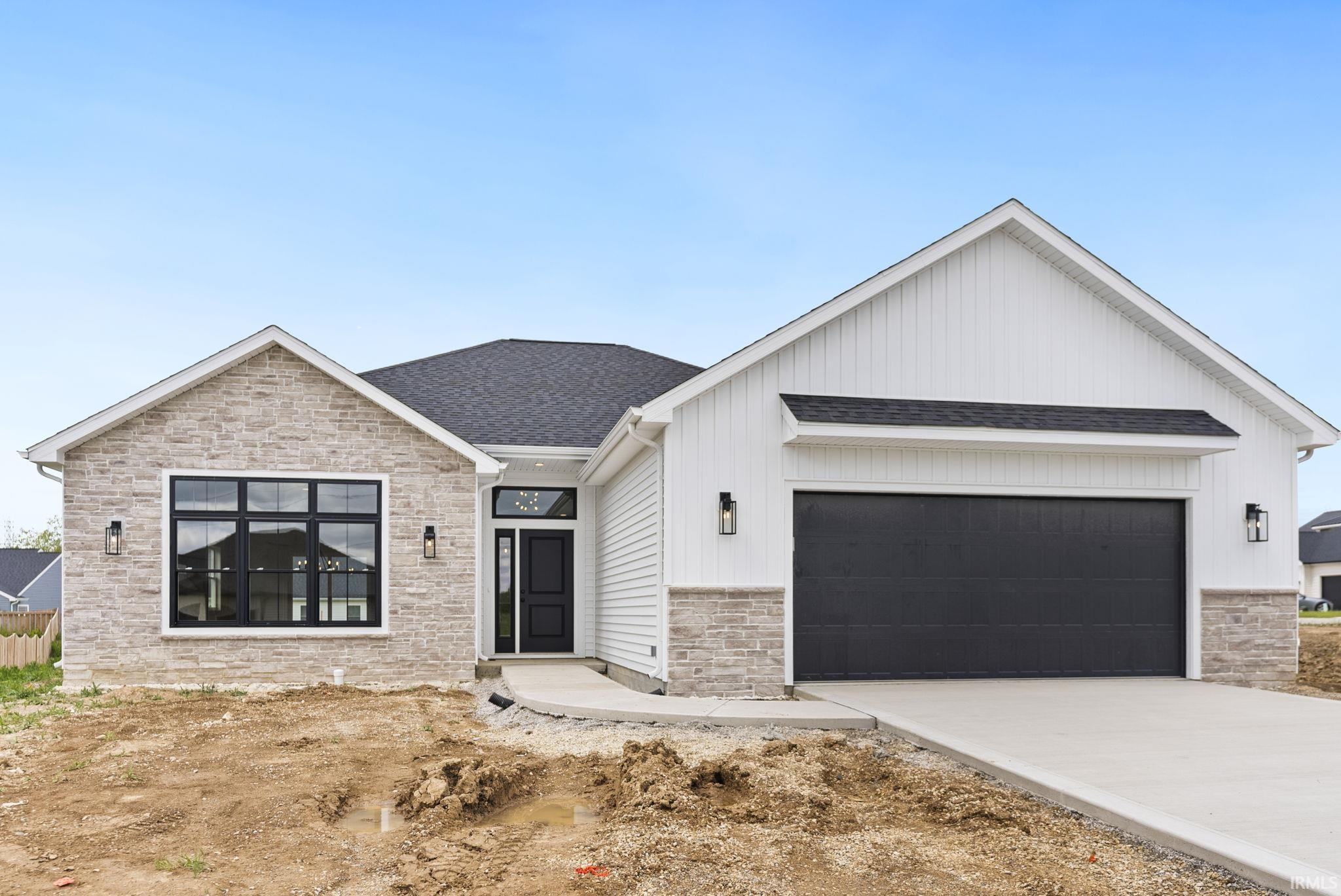 Modern facade featuring stone veneer and white vertical siding