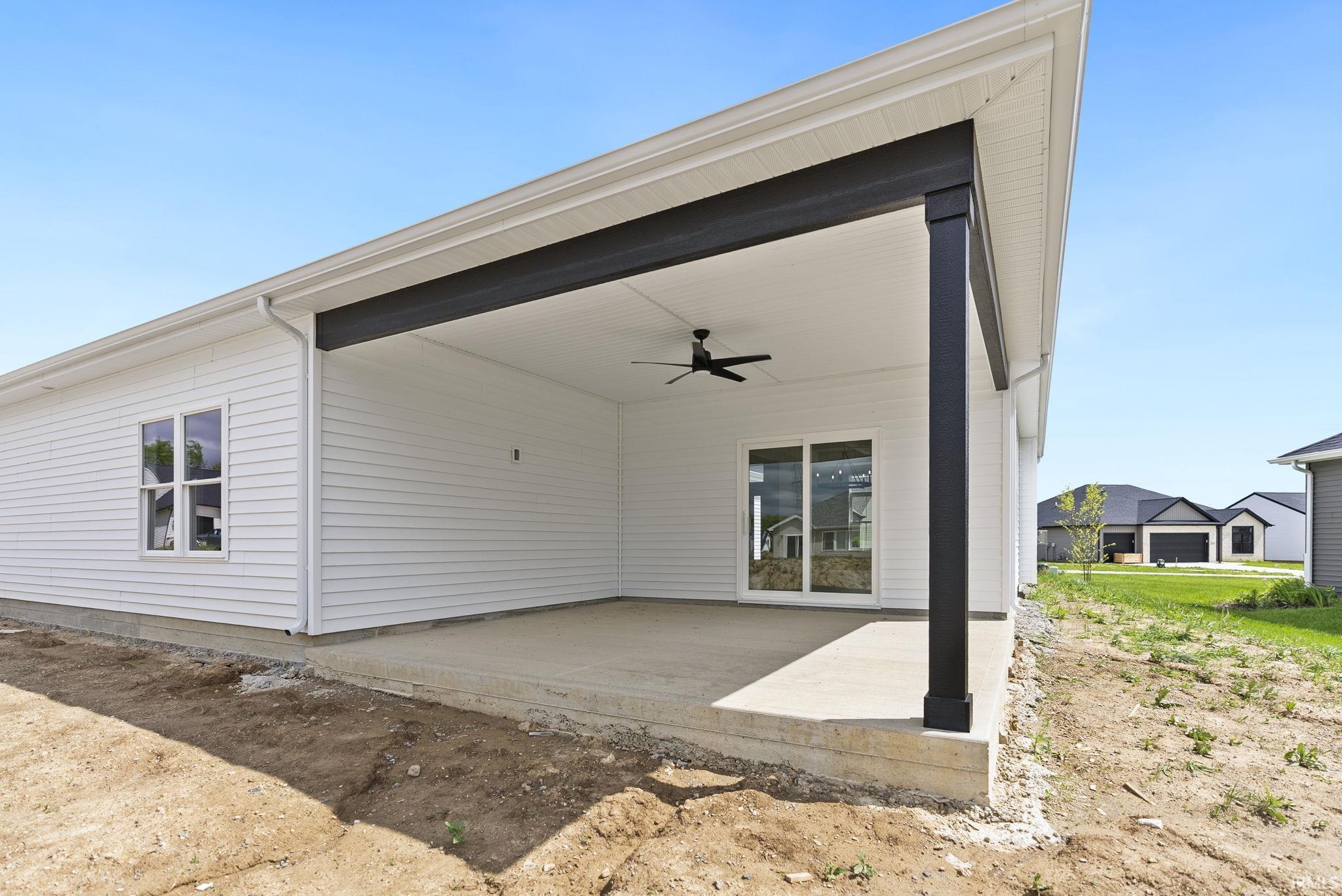 Concrete patio with a black ceiling fan, recessed lighting, and a sliding glass door