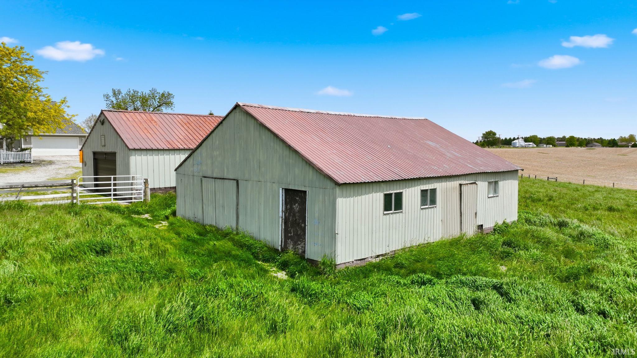 Exterior structures featuring corrugated metal siding and red metal roofs