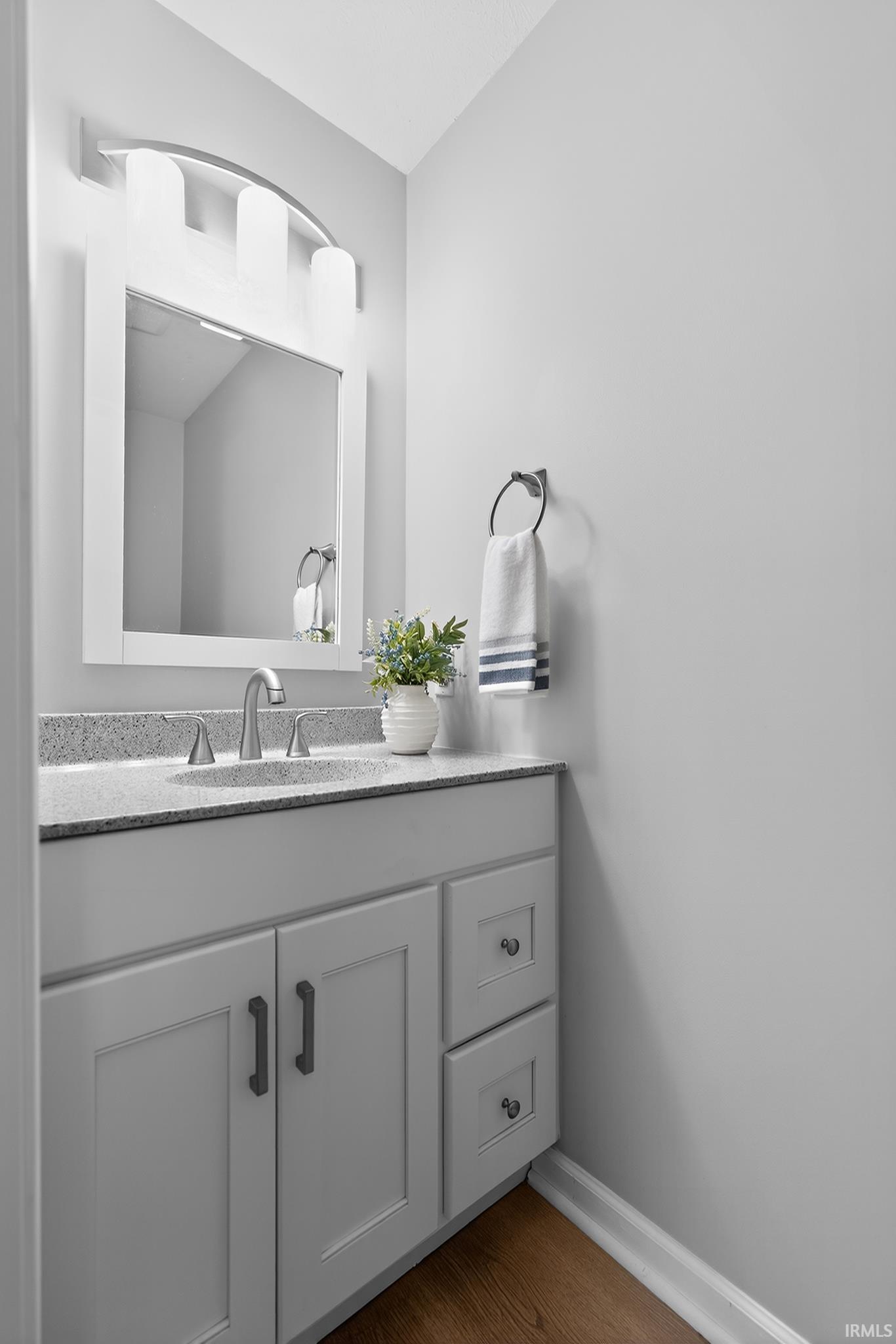 Vanity with a speckled countertop and an undermount sink