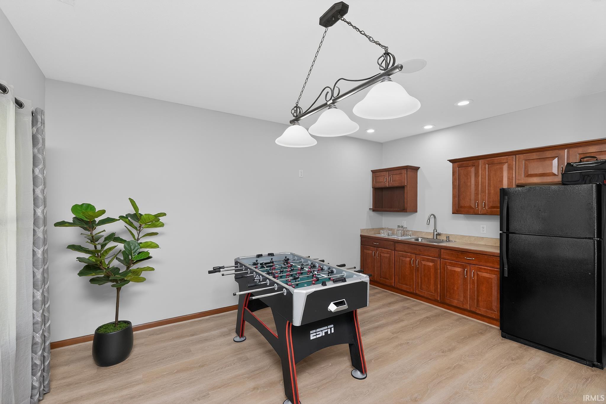 Entertainment room featuring wood-finish flooring and light gray walls