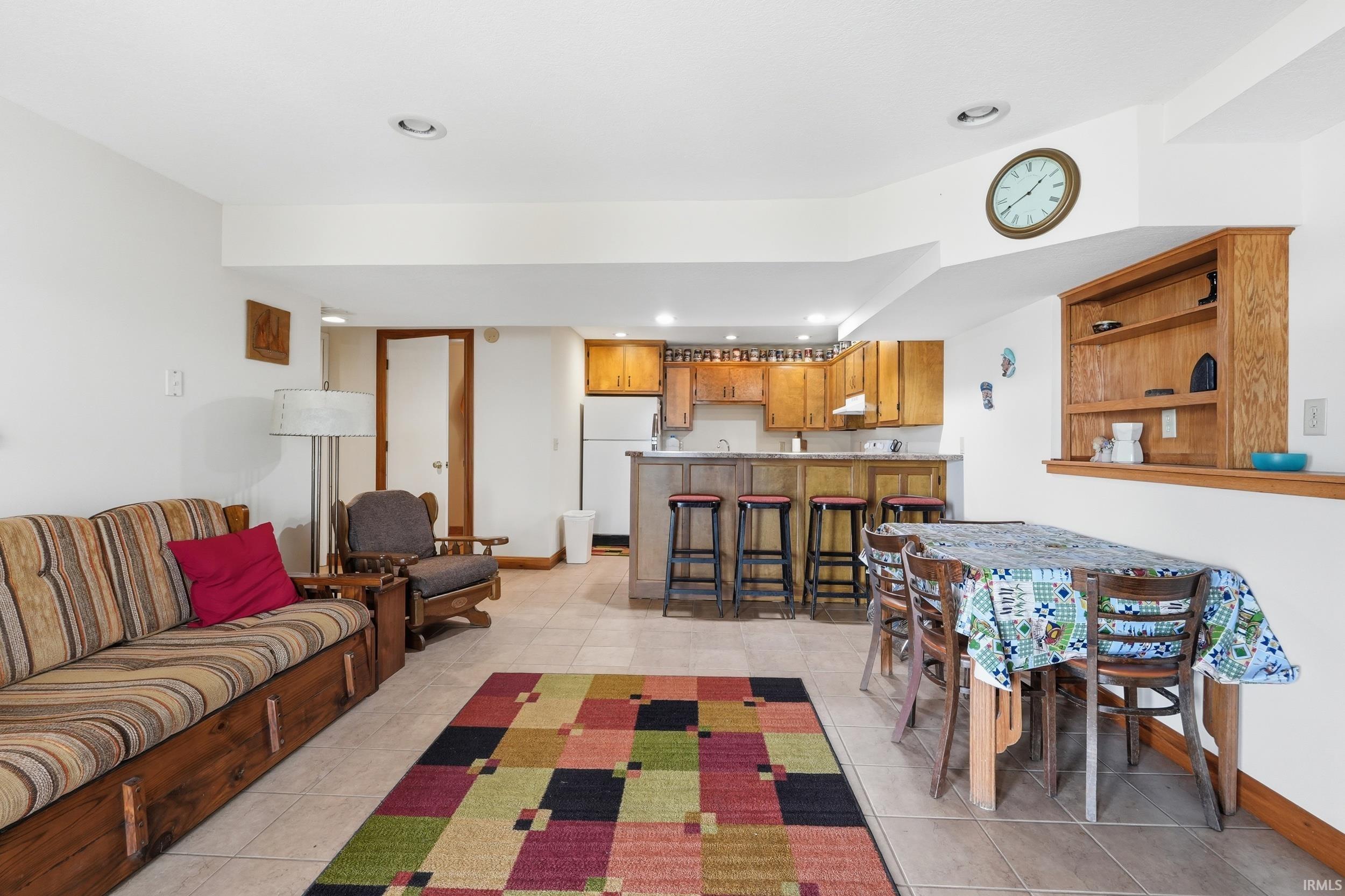 Open-concept common area featuring tile flooring, recessed lighting, and a built-in shelving unit