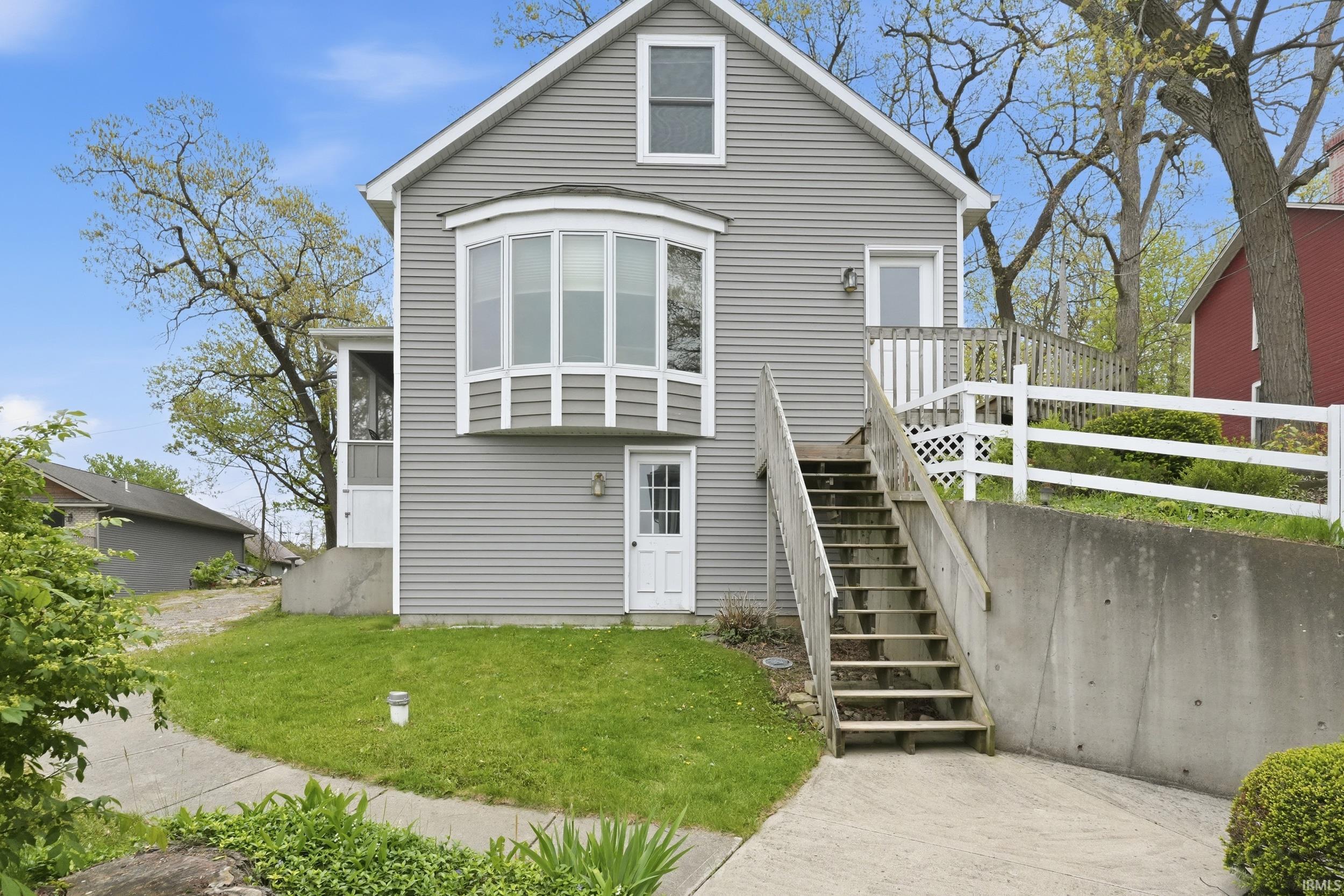 Gray siding exterior with a prominent bay window