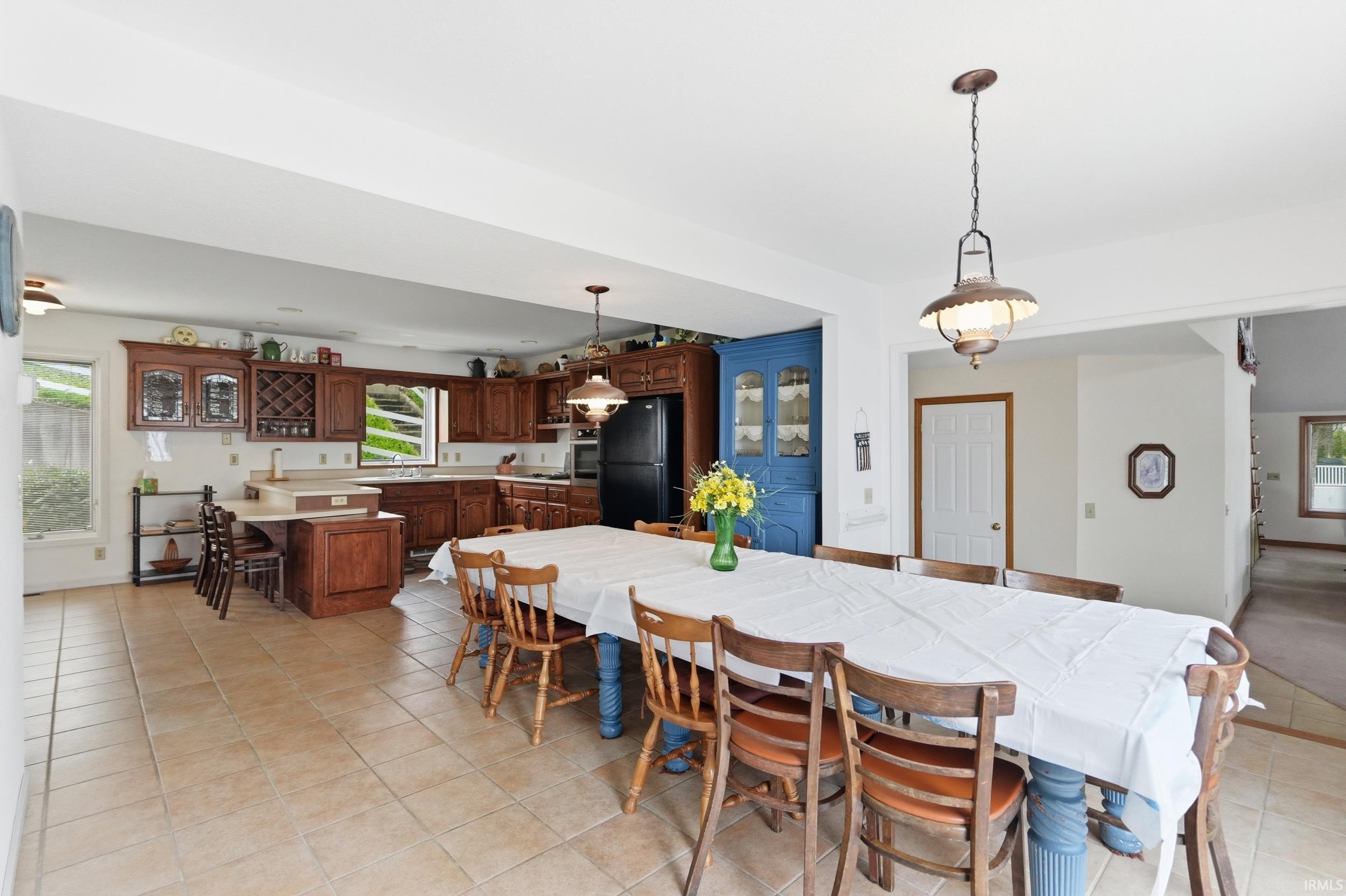 Spacious kitchen and dining area with tile flooring