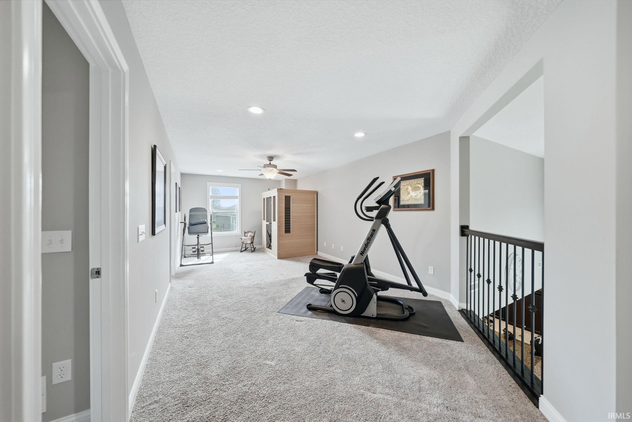 Carpeted bonus room featuring recessed lighting, a ceiling fan, and a window providing natural light