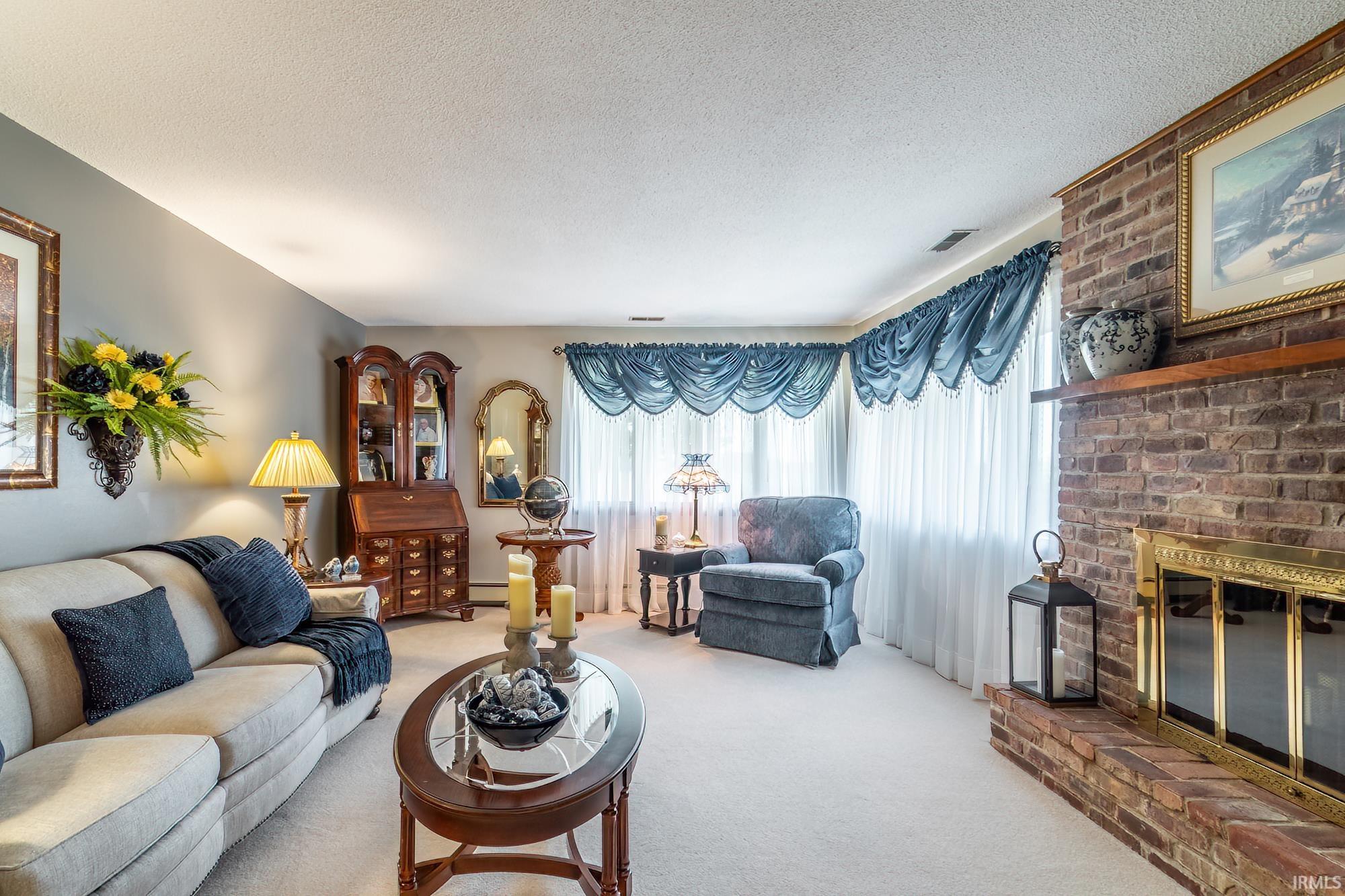 Brick fireplace with a brass firebox and a wood mantel