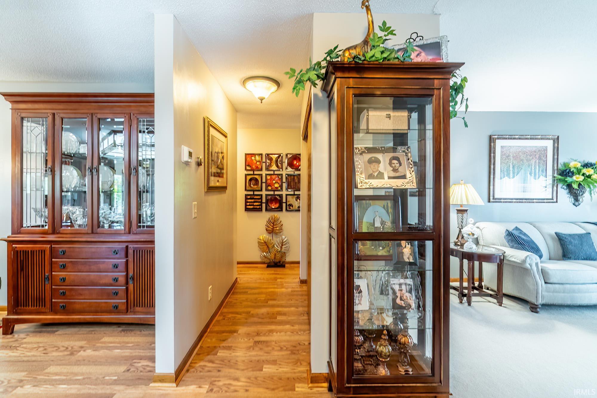 Hallway featuring wood-finish flooring and a ceiling-mounted light fixture