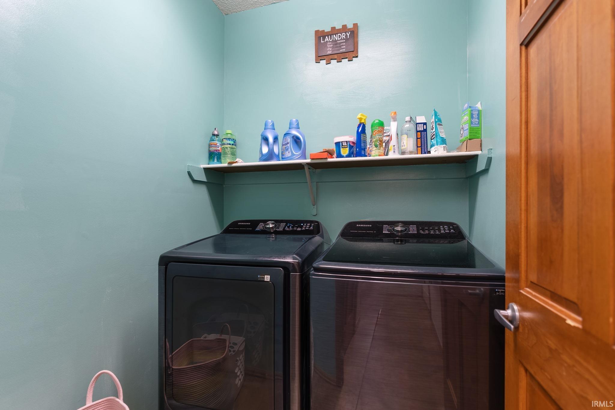 Dedicated utility space with a light-colored wall shelf, featuring a durable wooden doorframe