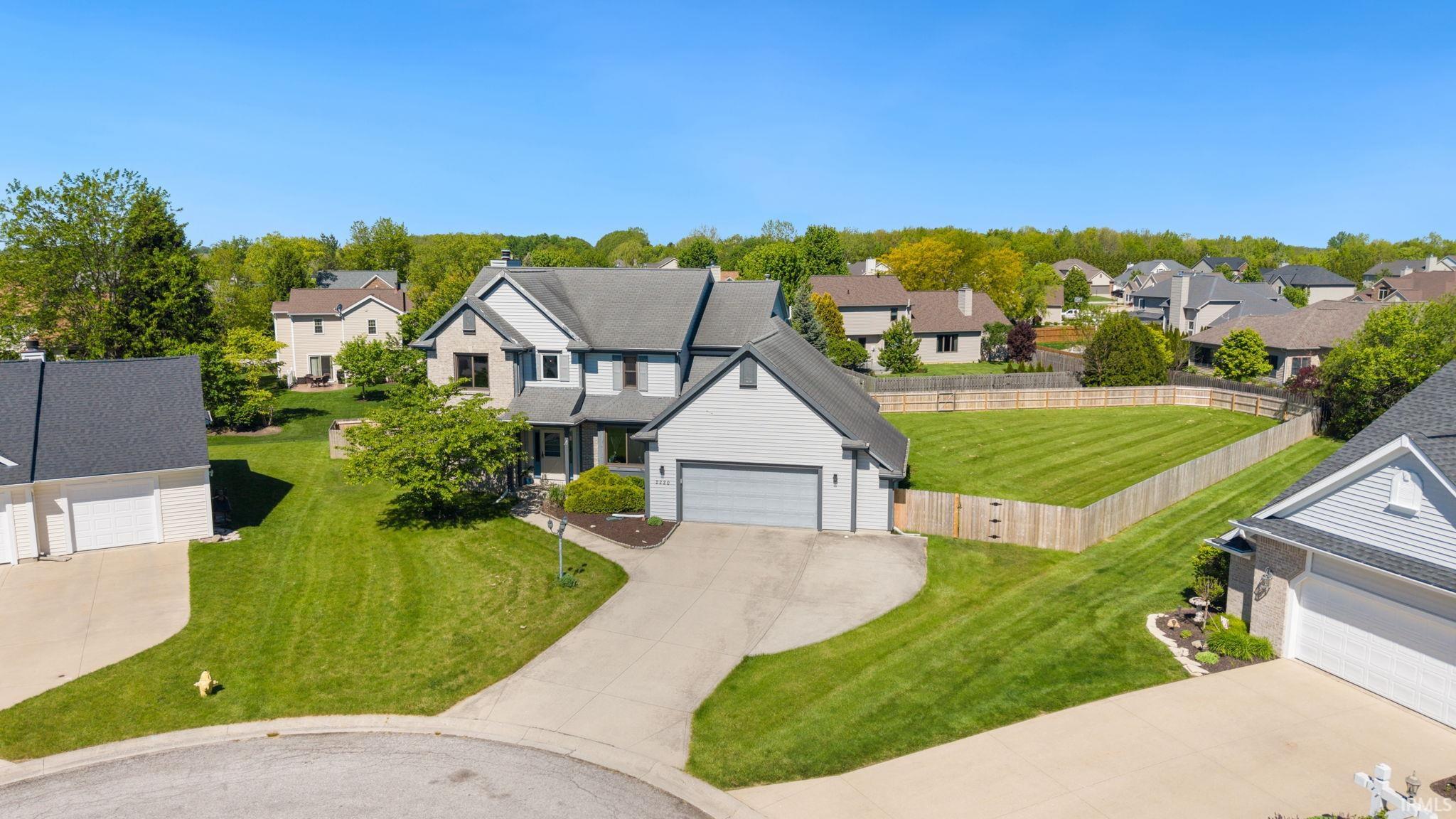 Contemporary residence featuring a light gray exterior with dark trim accents
