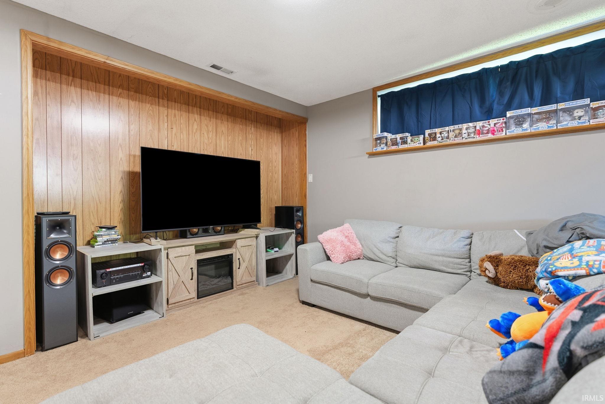 Recreation area with wood paneling accent wall