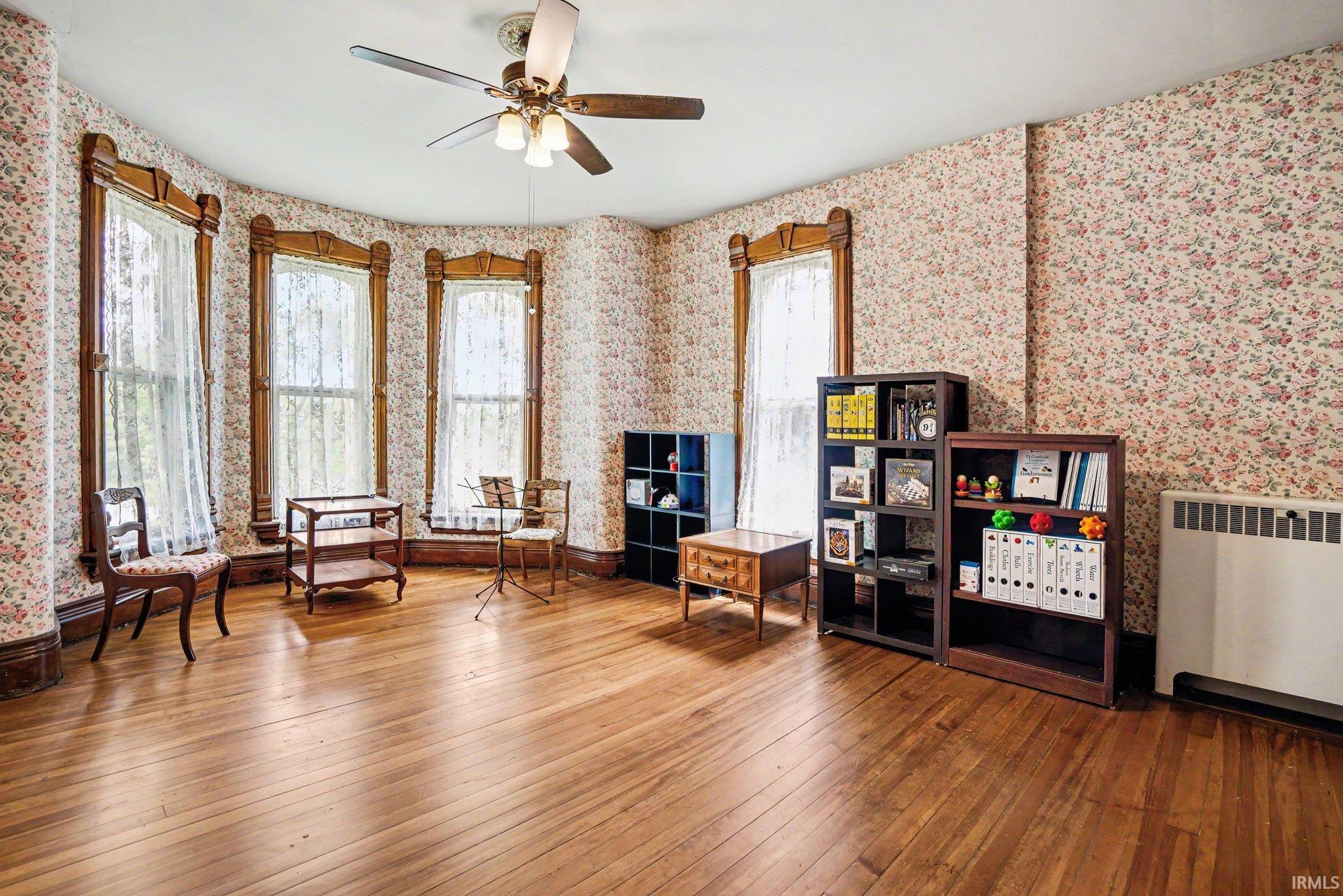 2nd bedroom. Very large room with wood-finish flooring, gorgeous windows, and a ceiling fan