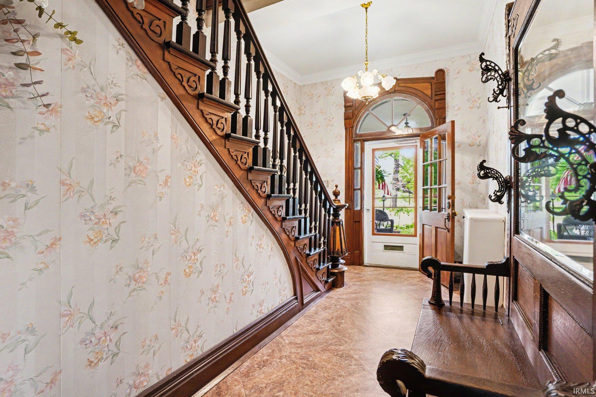 Ornate wooden staircase with decorative newel posts and balusters