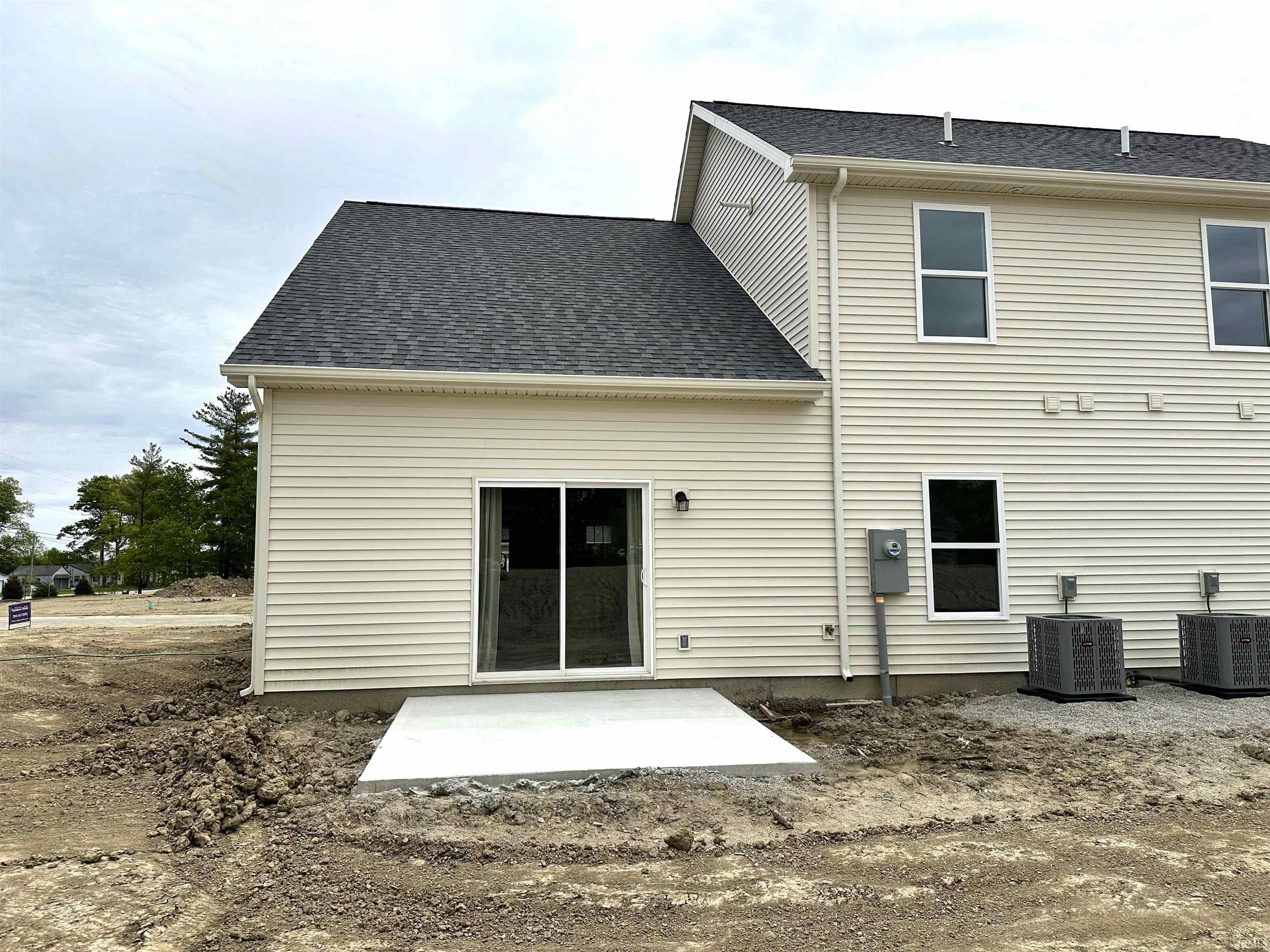 Cream-toned vinyl siding exterior with an asphalt shingle roof