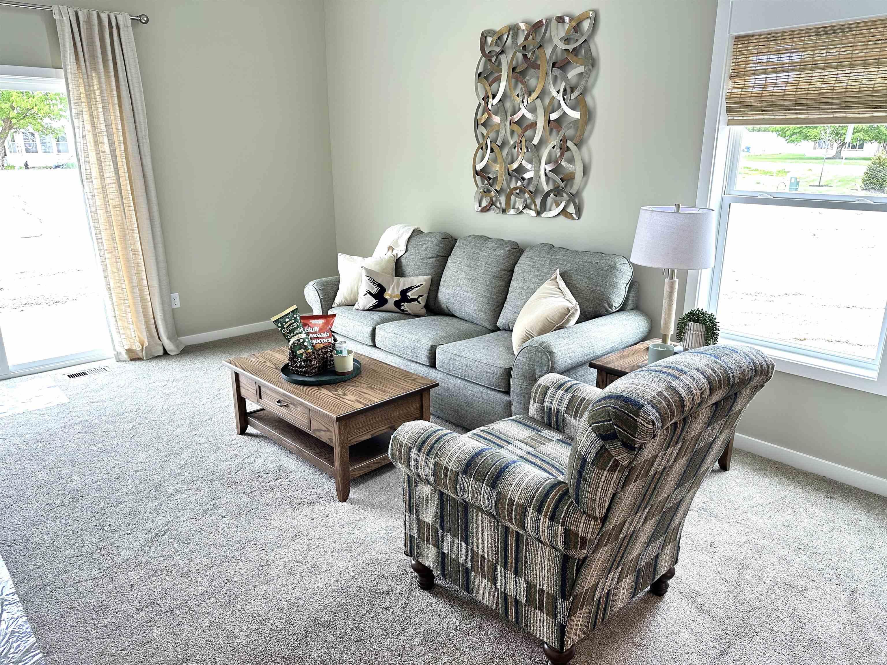 Living area featuring light-colored wall paint and neutral carpeting
