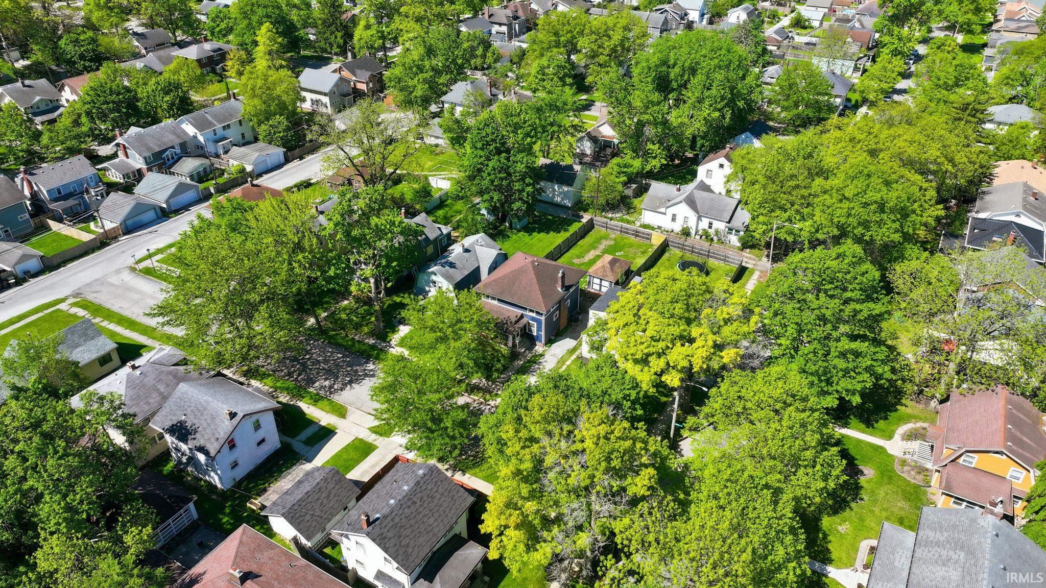Aerial perspective showcasing residential properties with mature tree canopy and established street infrastructure