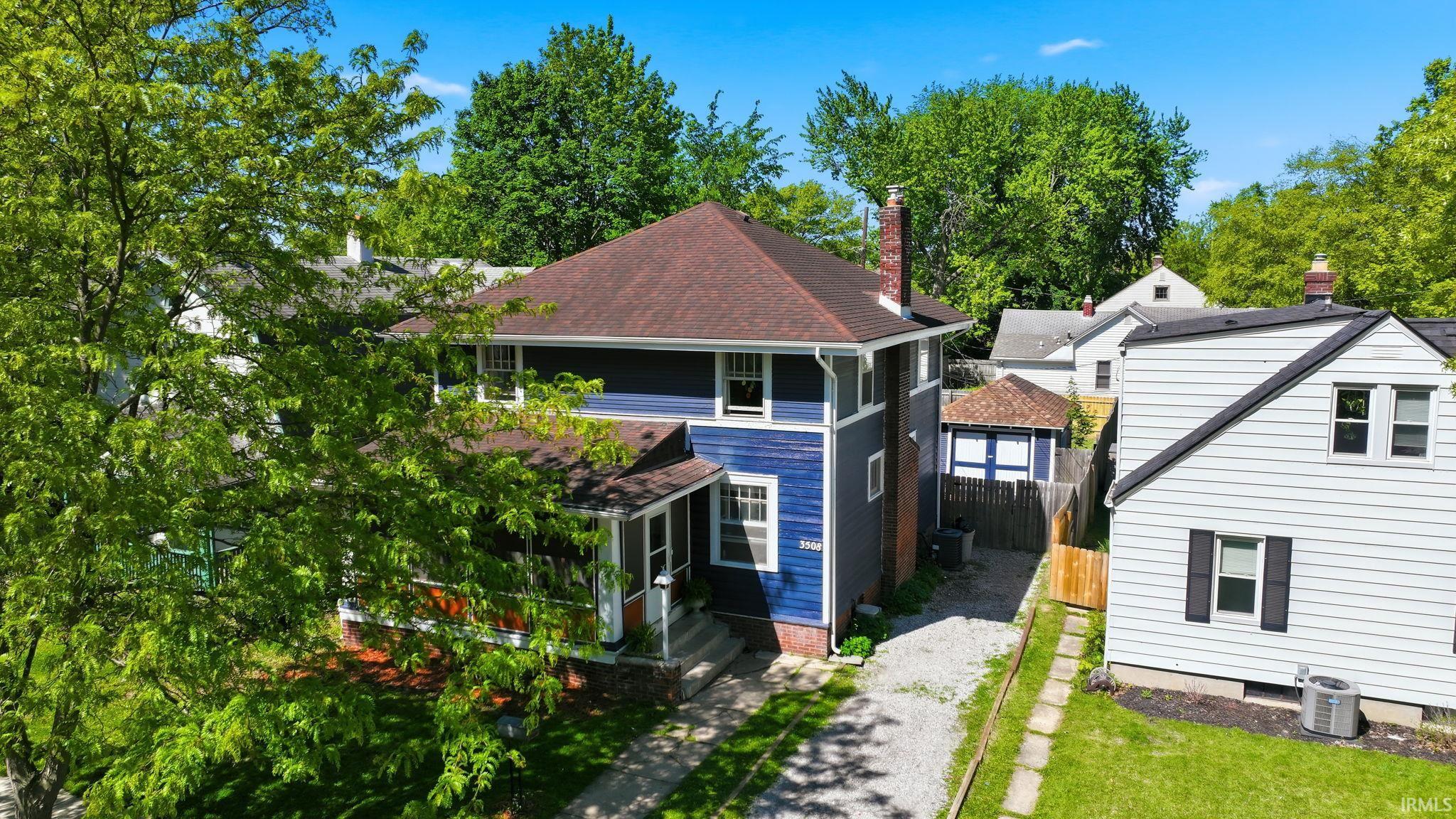 Two-story property with deep blue siding and a dark shingle roof