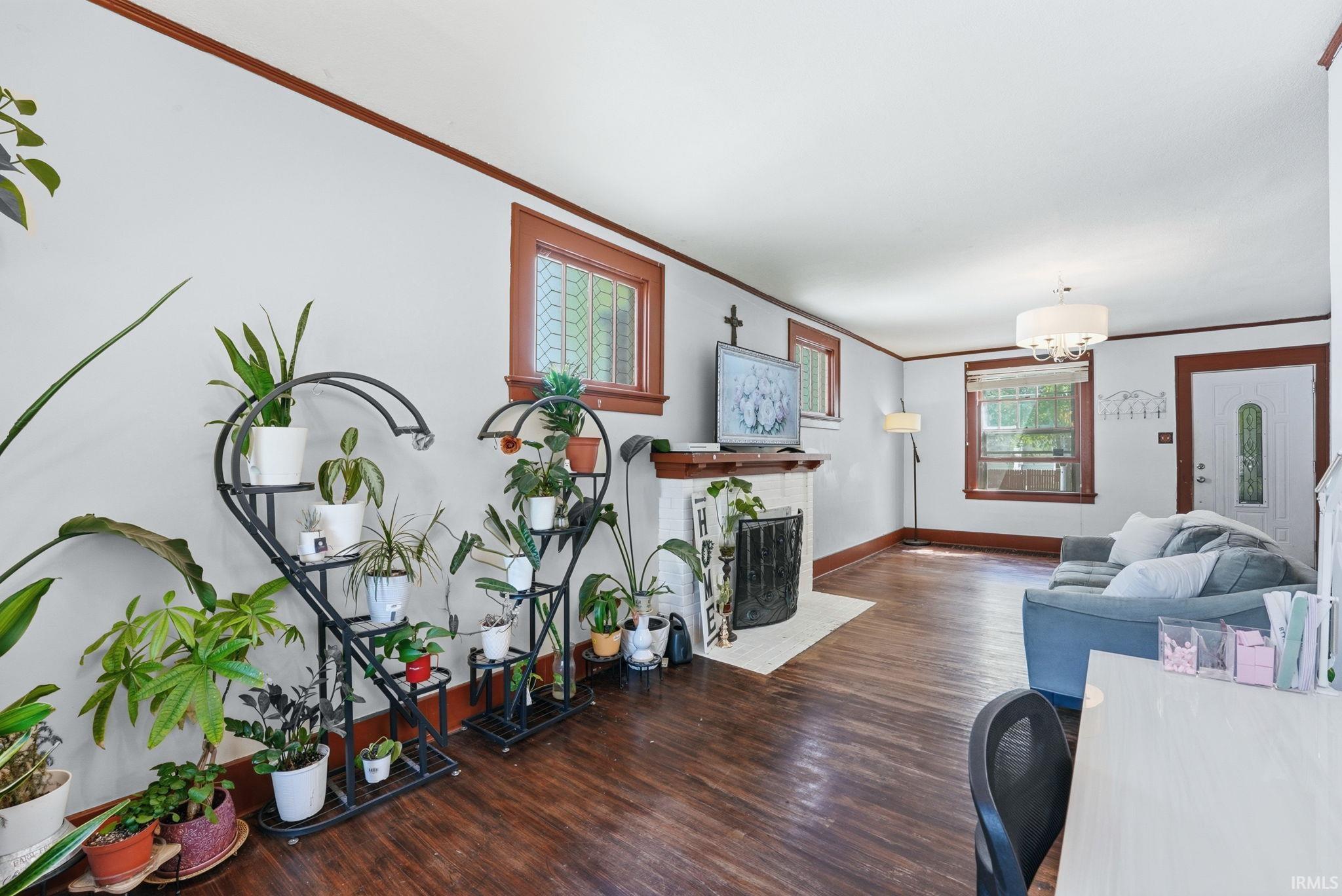 Living space featuring rich wood-finish flooring and white painted walls