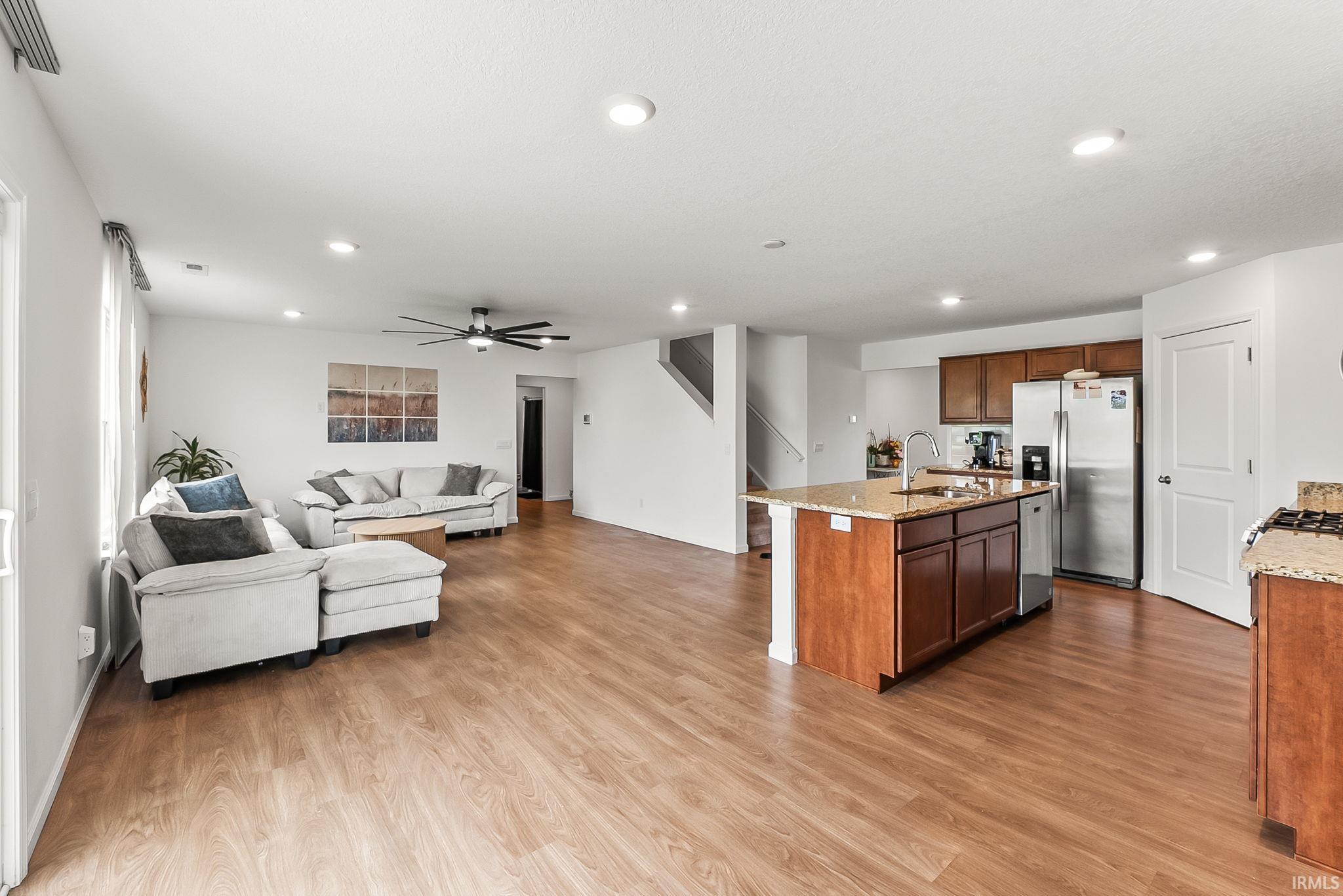 Open-concept living space featuring wood-finish flooring throughout