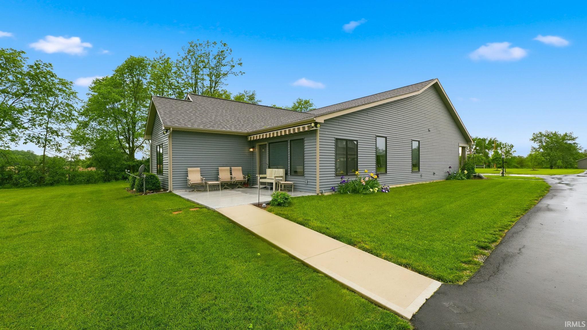 Gray siding exterior with an asphalt shingle roof