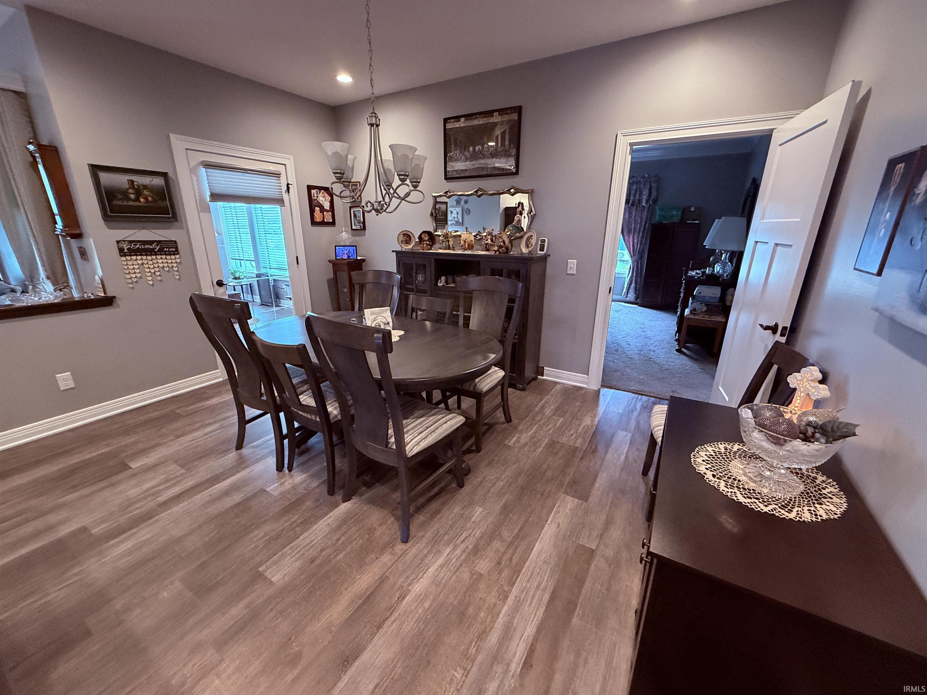 Dining area featuring a traditional chandelier, recessed lighting, and white trim