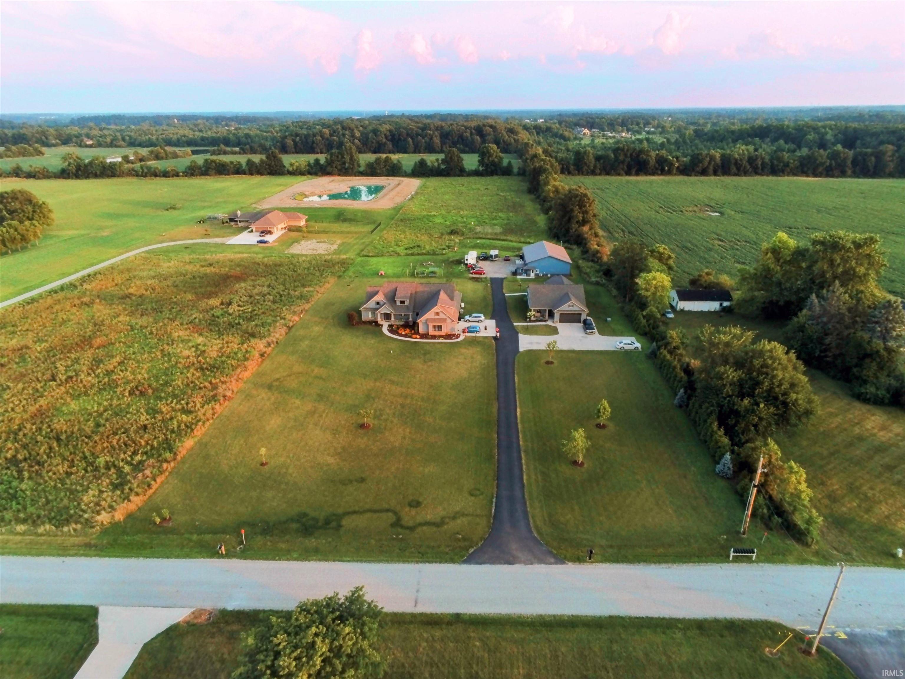 Aerial perspective showcasing expansive green spaces and tree line