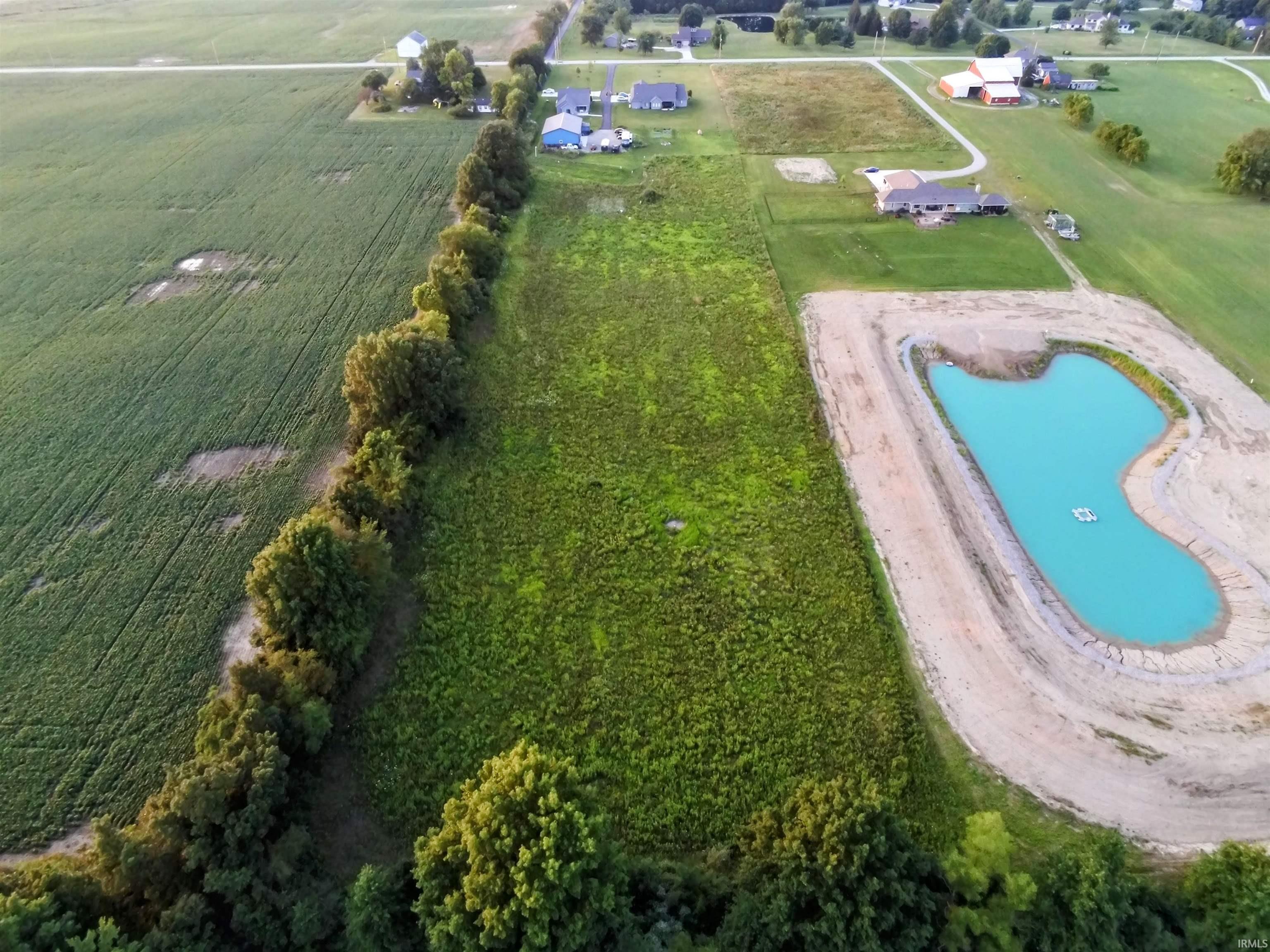 Expansive land featuring a tree line