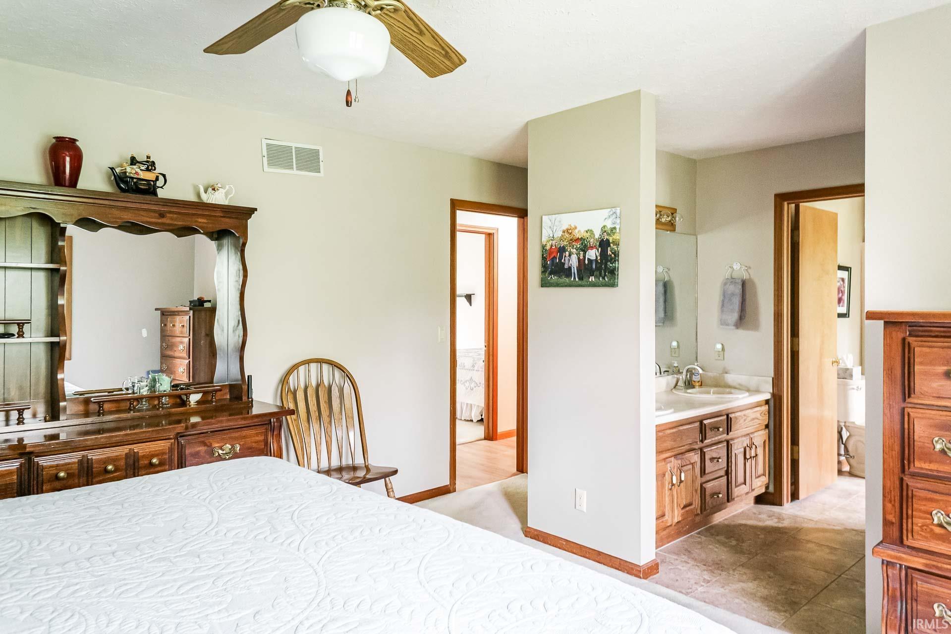 Bedroom featuring a ceiling fan, neutral wall color, and light-toned carpeting