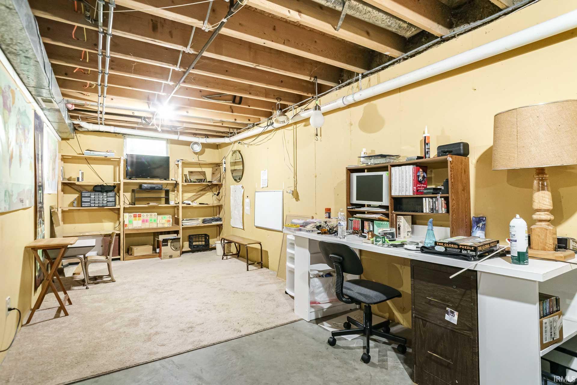 Lower level area featuring exposed ceiling joists and ductwork