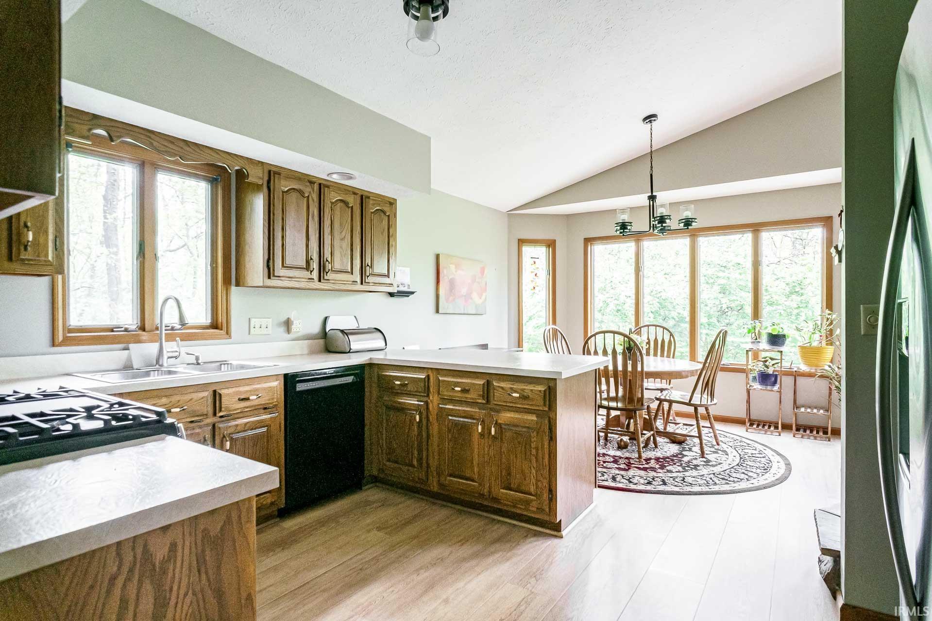 Kitchen featuring wood-finish cabinetry and light-toned countertops