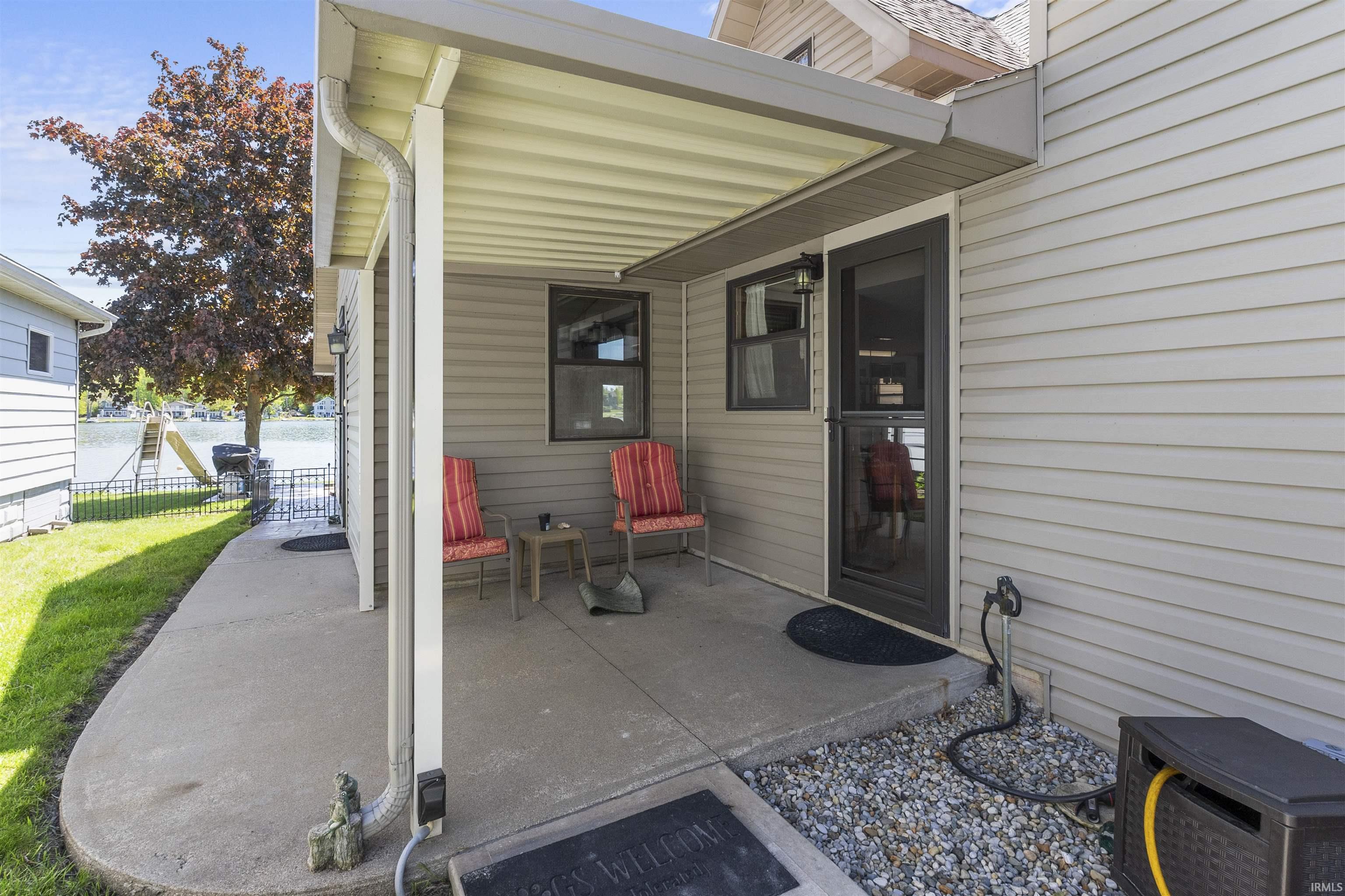 Covered concrete patio featuring siding exterior