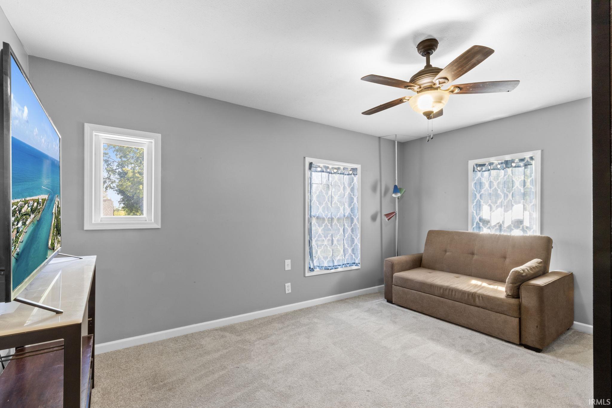 Bedroom featuring neutral-toned walls and plush carpeting