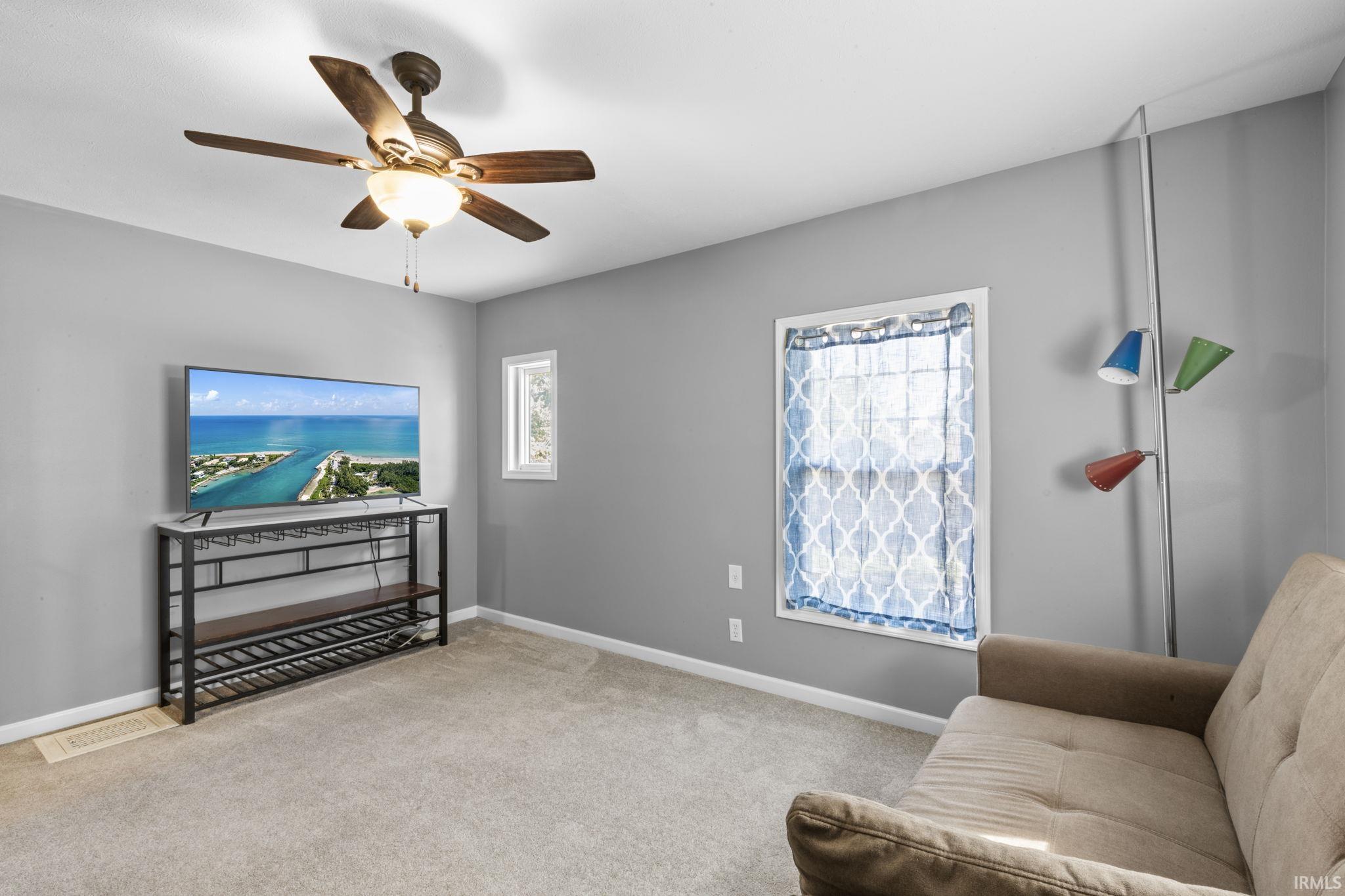 Neutral gray wall finishes complement light-toned carpeting