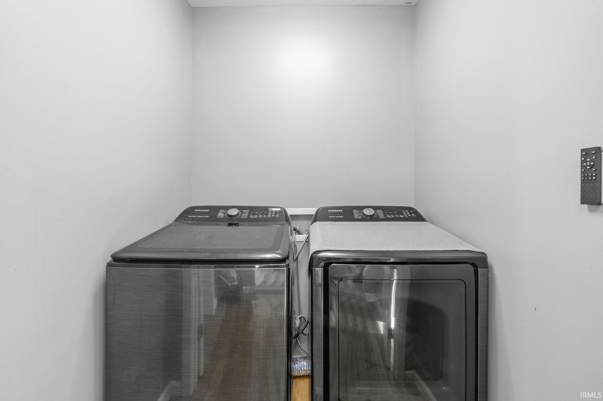 Dedicated laundry space featuring white walls and a built-in light fixture